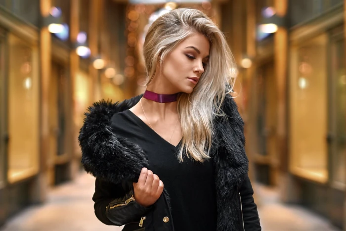 women s black V neck shirt and parka coat pose glare background 2k