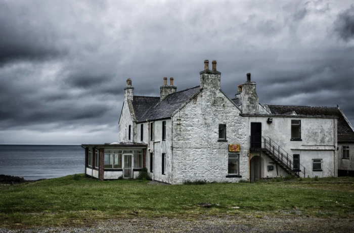 gray and black concrete house near body of water home sea coast 2k 4k 5k