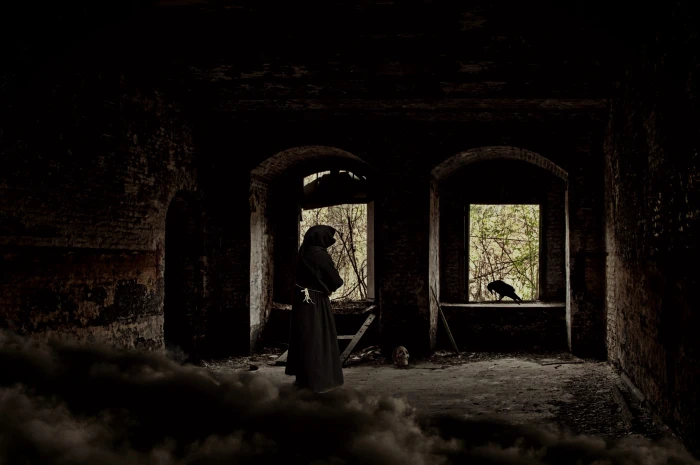 person wearing gray robe standing near window man ruin castle 2k 4k