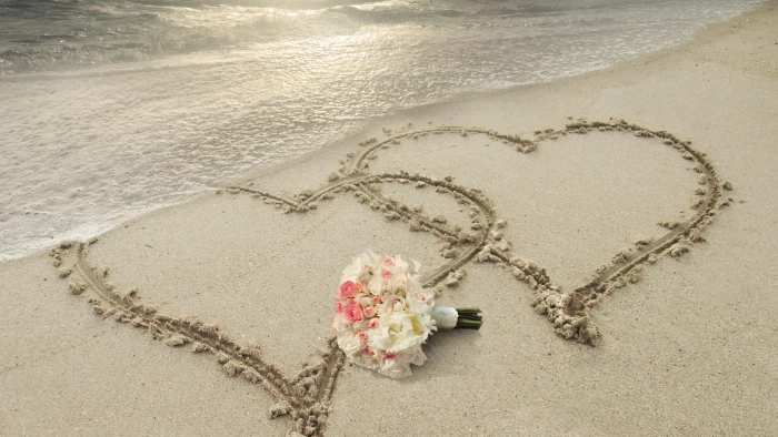 white and pink chrysanthemums bouquet on sand with two hearts seashore at daytime 2k 4k 5k 8k