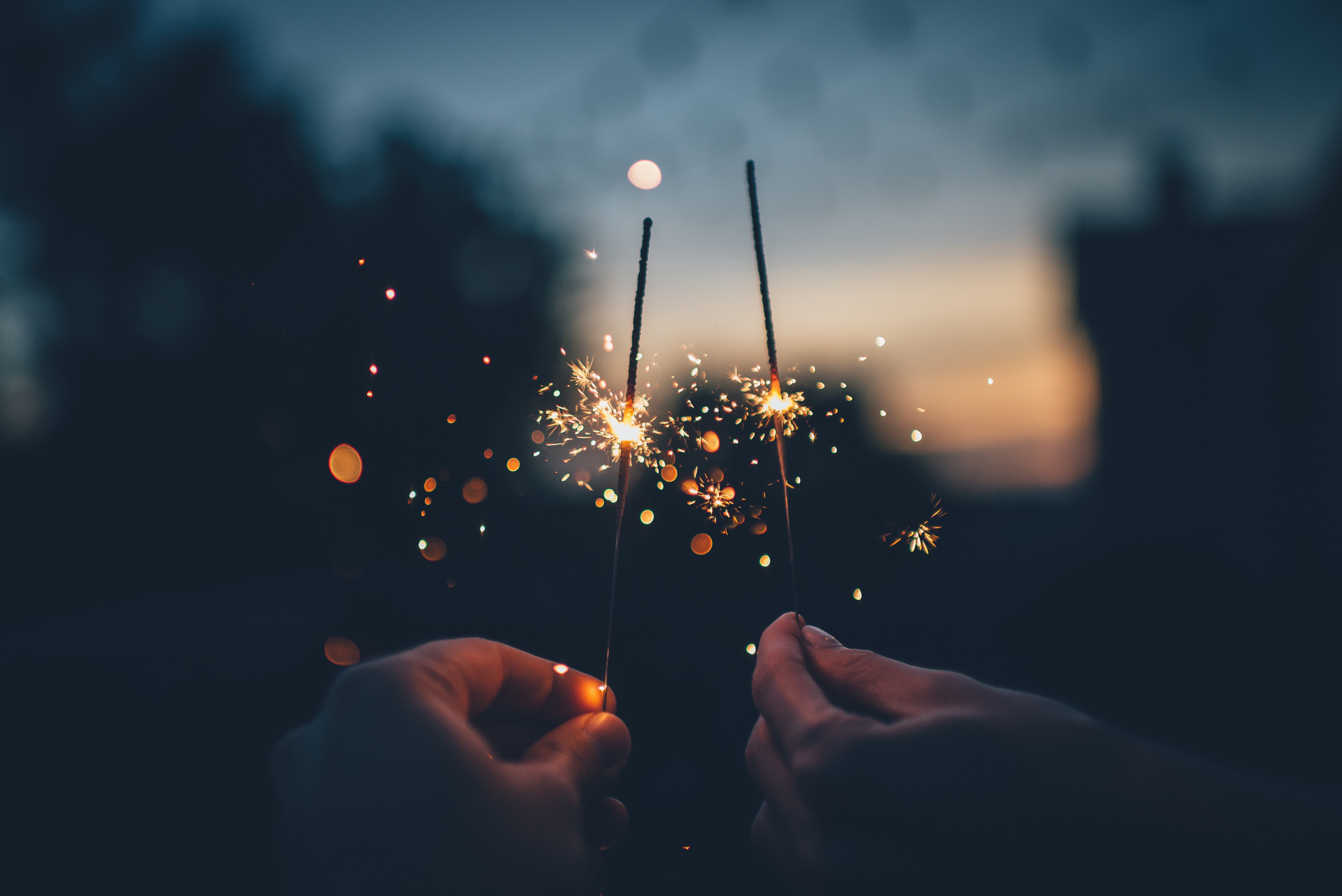 person holding fire cracker shallow focus photography two persons firework sticks 2k 4k 5k