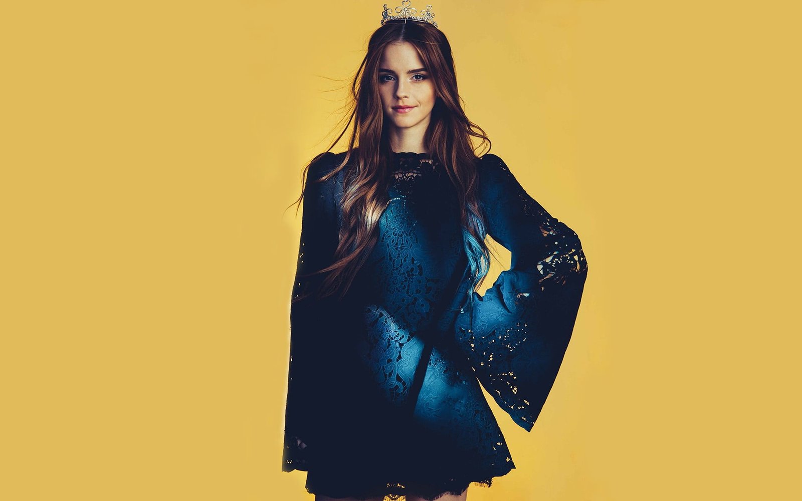 Emma Watson in blue and black long sleeved dress wearing silver tiara