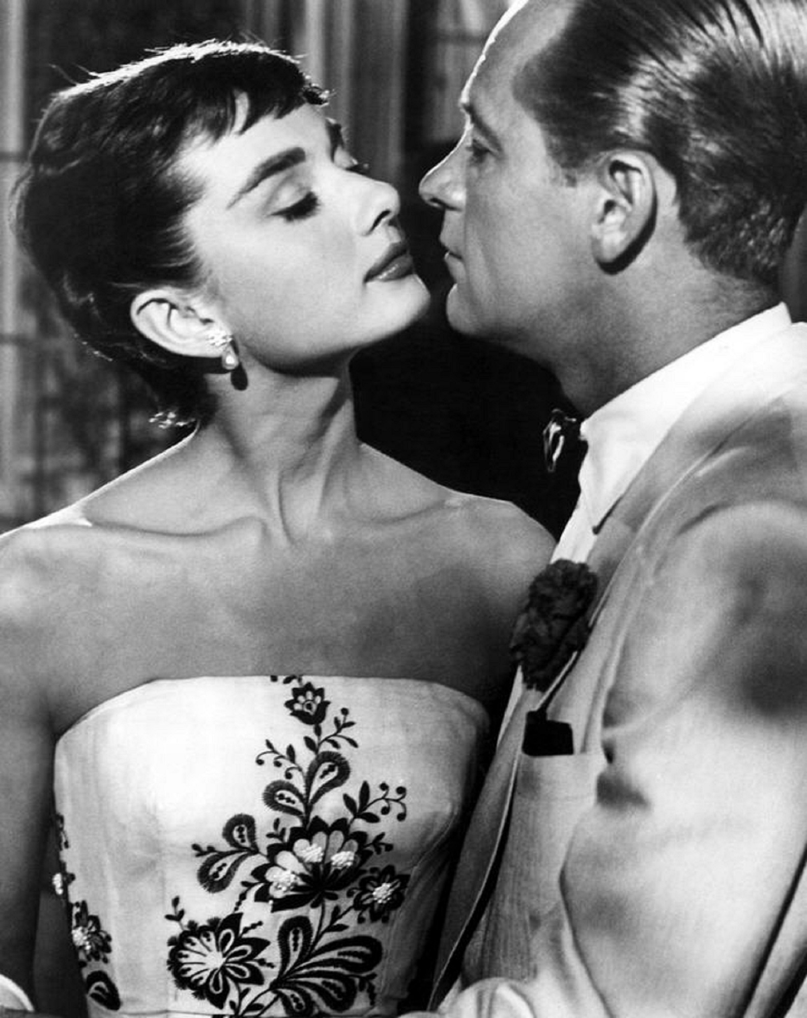 grayscale photo of Audrey Hepburn facing man william holden
