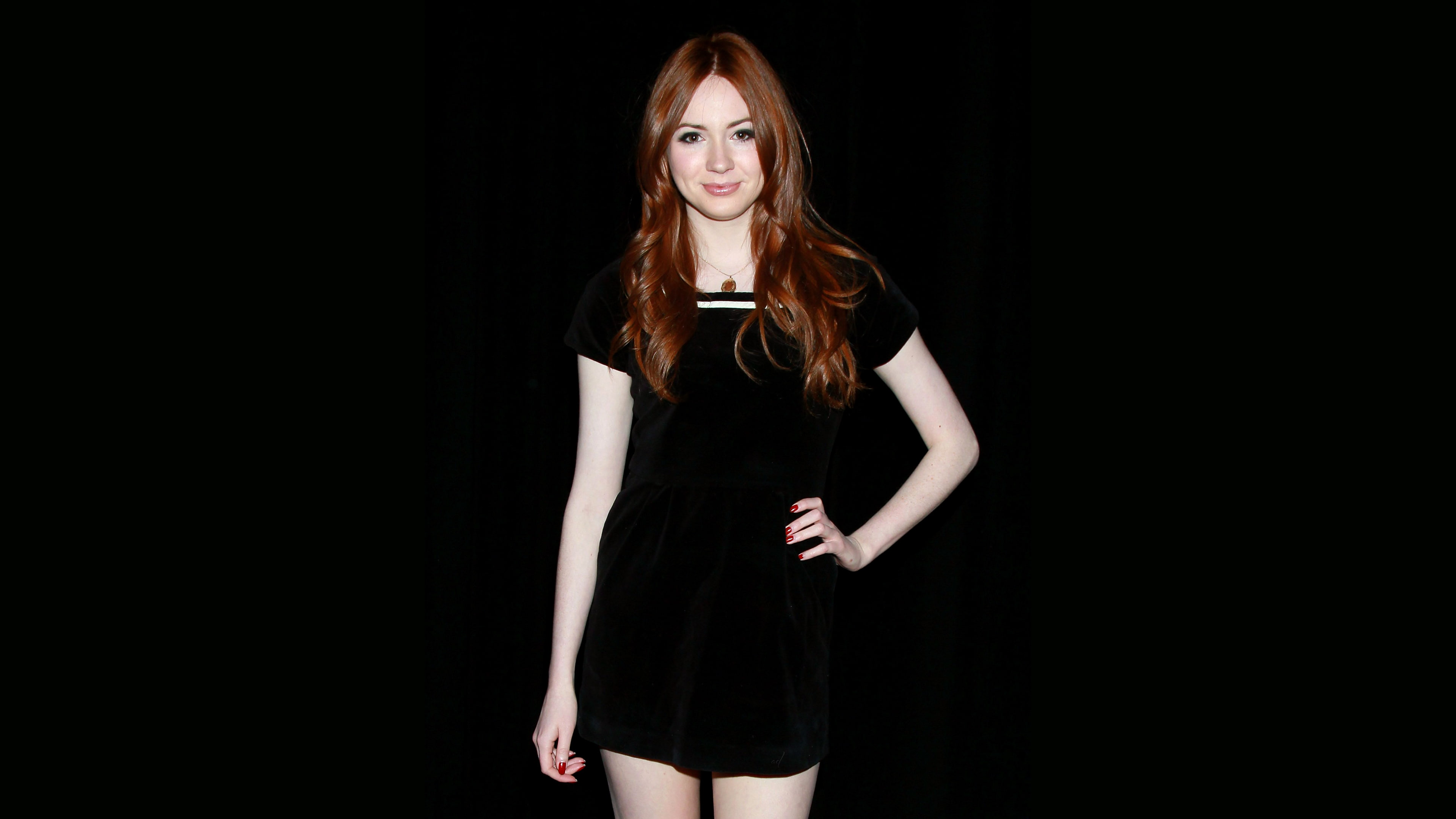 Karen Gillan redhead actress hands on hips black background 2k