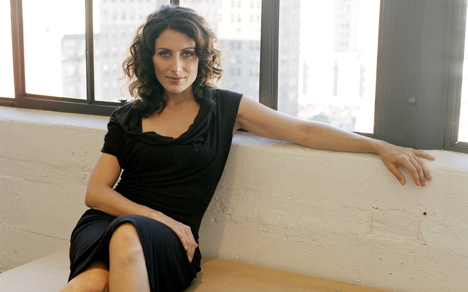 Lisa Edelstein mature women curly hair black dress sitting