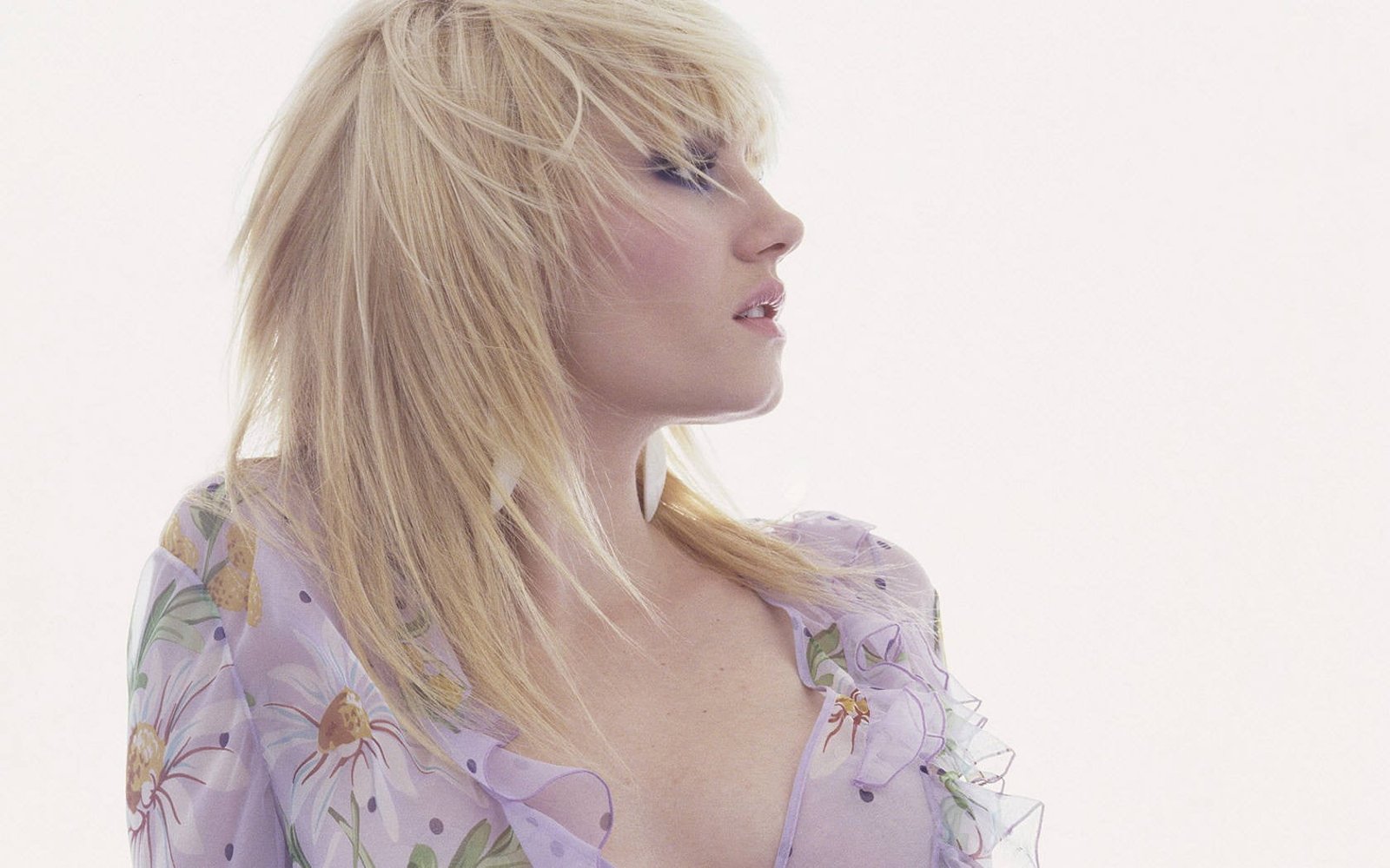 portrait photography of woman wearing purple and white floral top