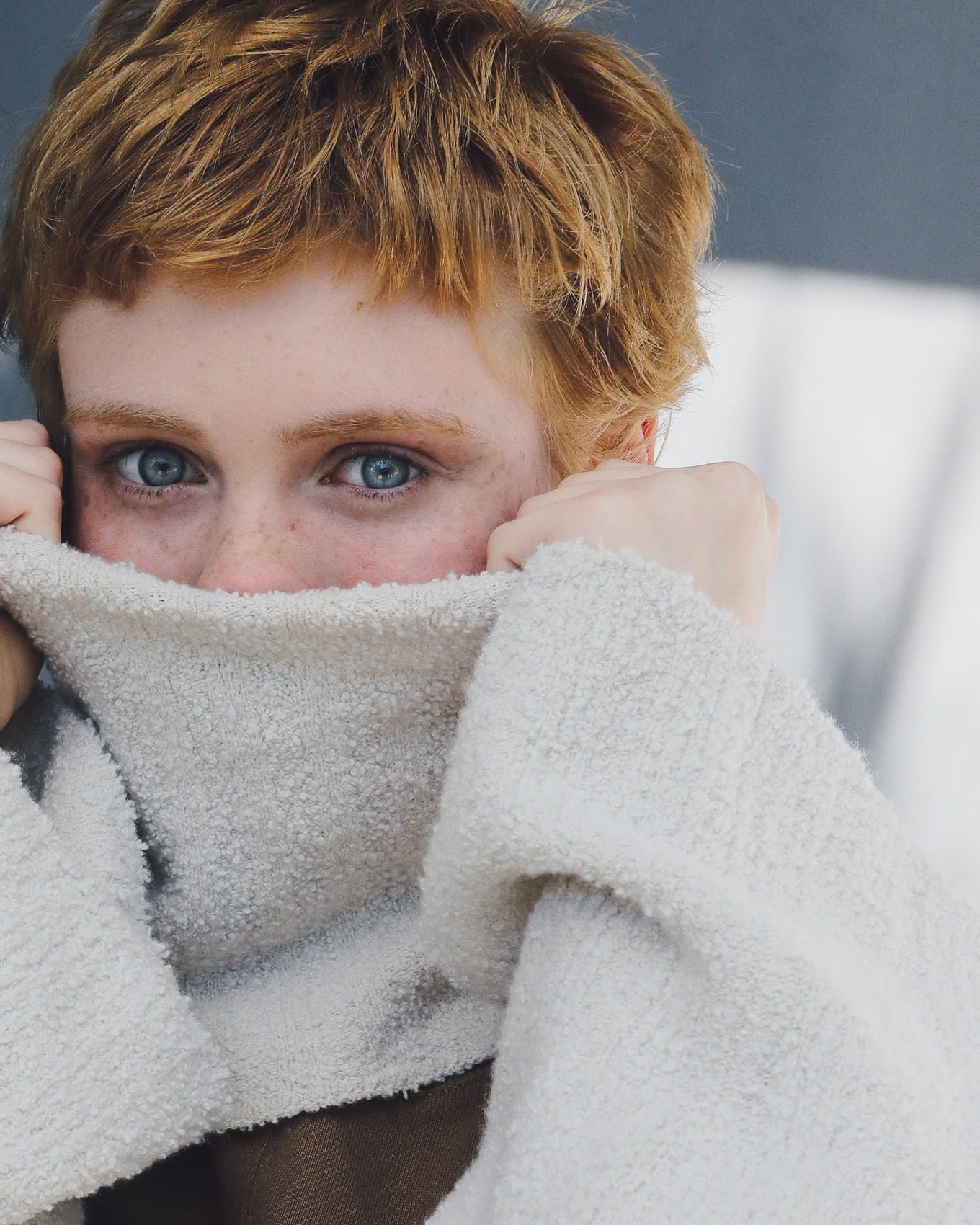 Sophia Lillis actress covering face sweater one person