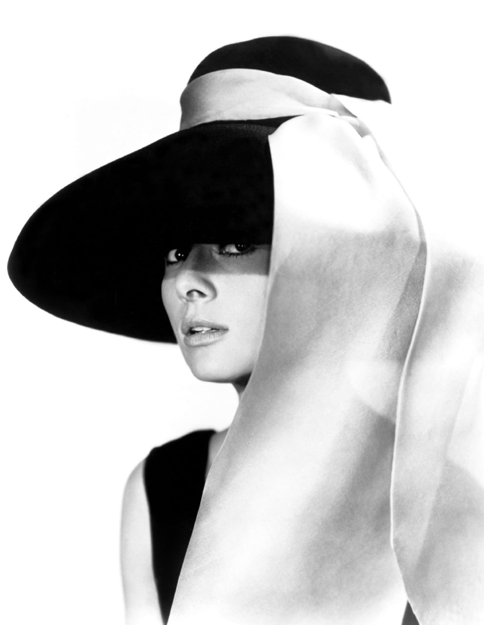 woman in black sleeveless dress and hat photo audrey hepburn