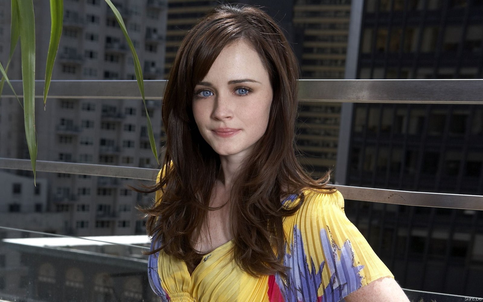 woman in yellow and blue top posing for photo during daytime