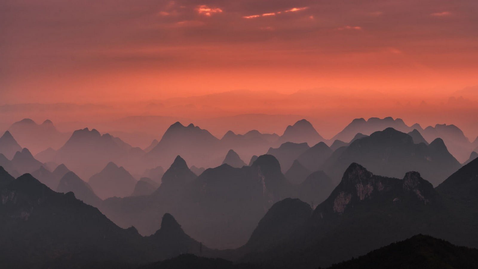 silhouette of mountains during sunset nature landscape mist 2k
