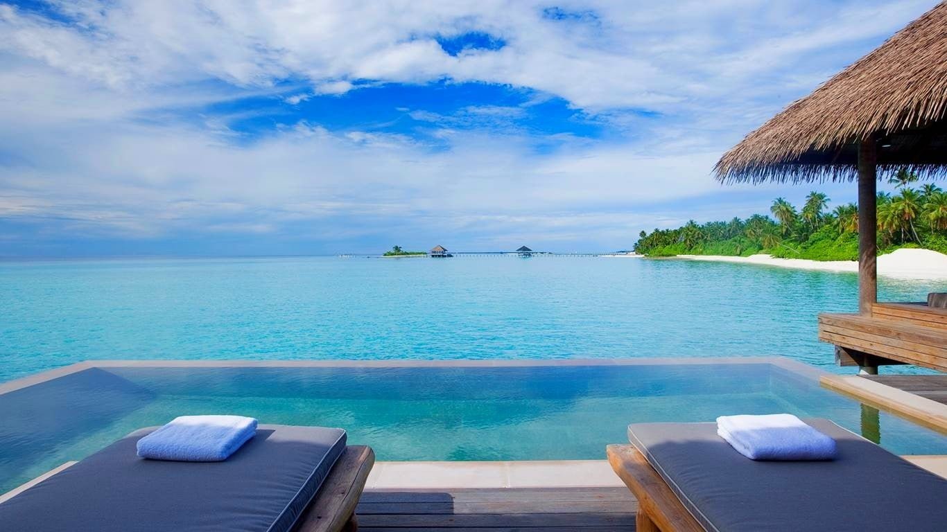 landscape photo of seashore swimming pool beach resort palm trees
