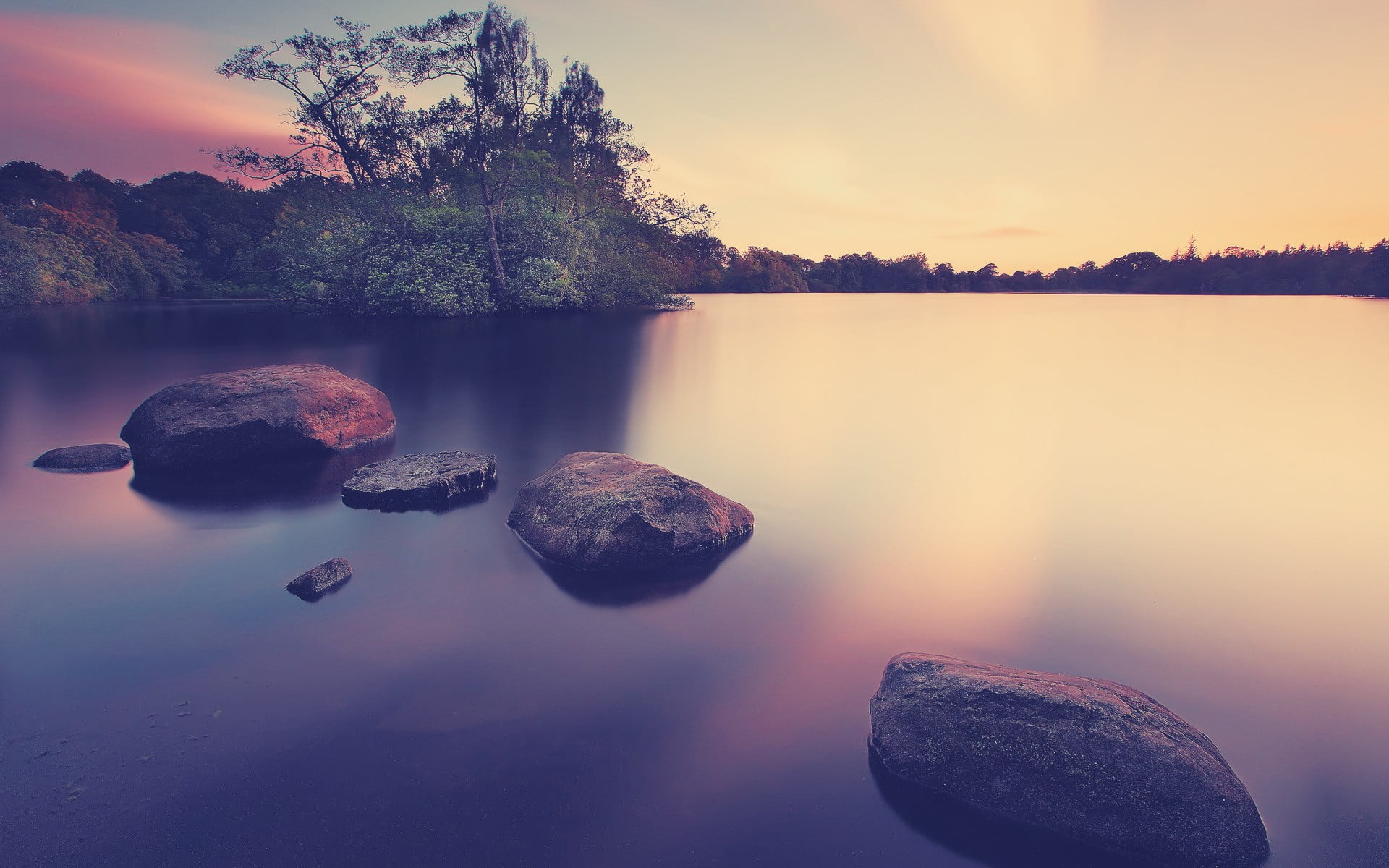 black stones calm body of water with rocks near trees during daytiem 2k