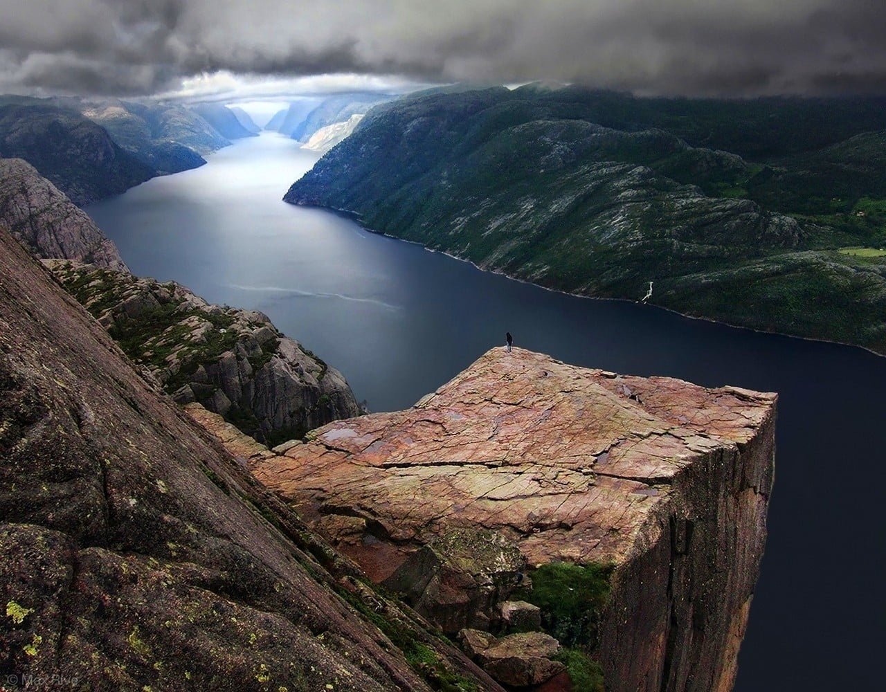 brown and black wooden table Preikestolen Norway fjord clouds