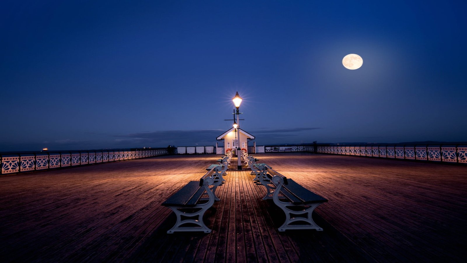 white wooden bench outdoor during full moon sand beach night 2k
