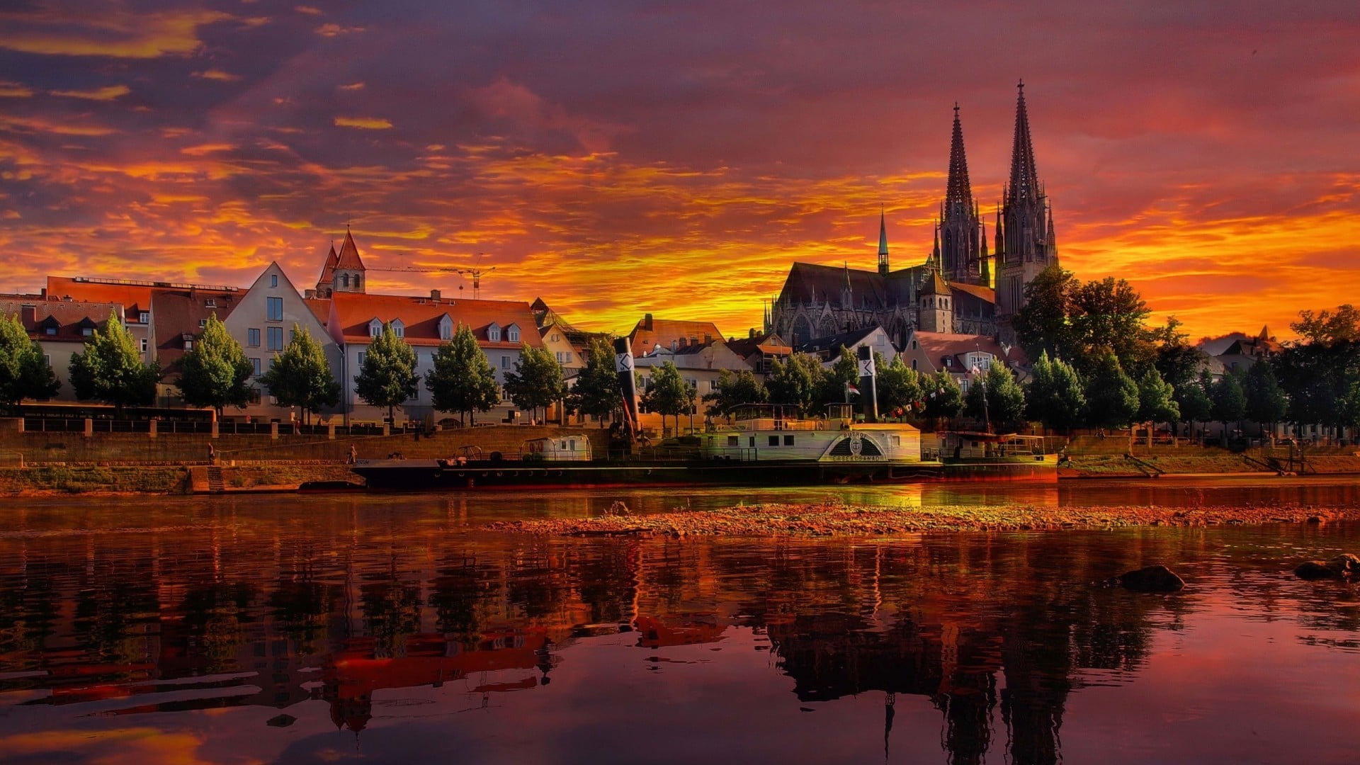 scenery of city building Regensburg sunset Donau river clouds 2k