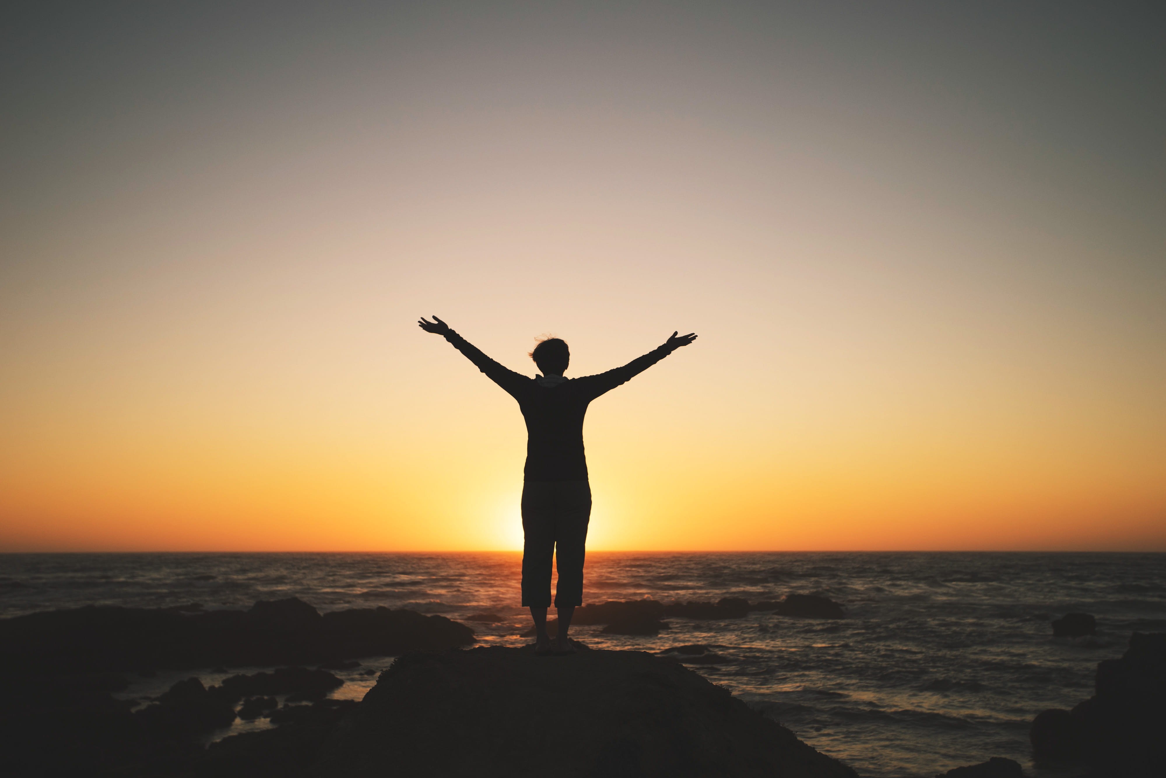 Silhouette of a person enjoying the sunset on coast people 2k 4k