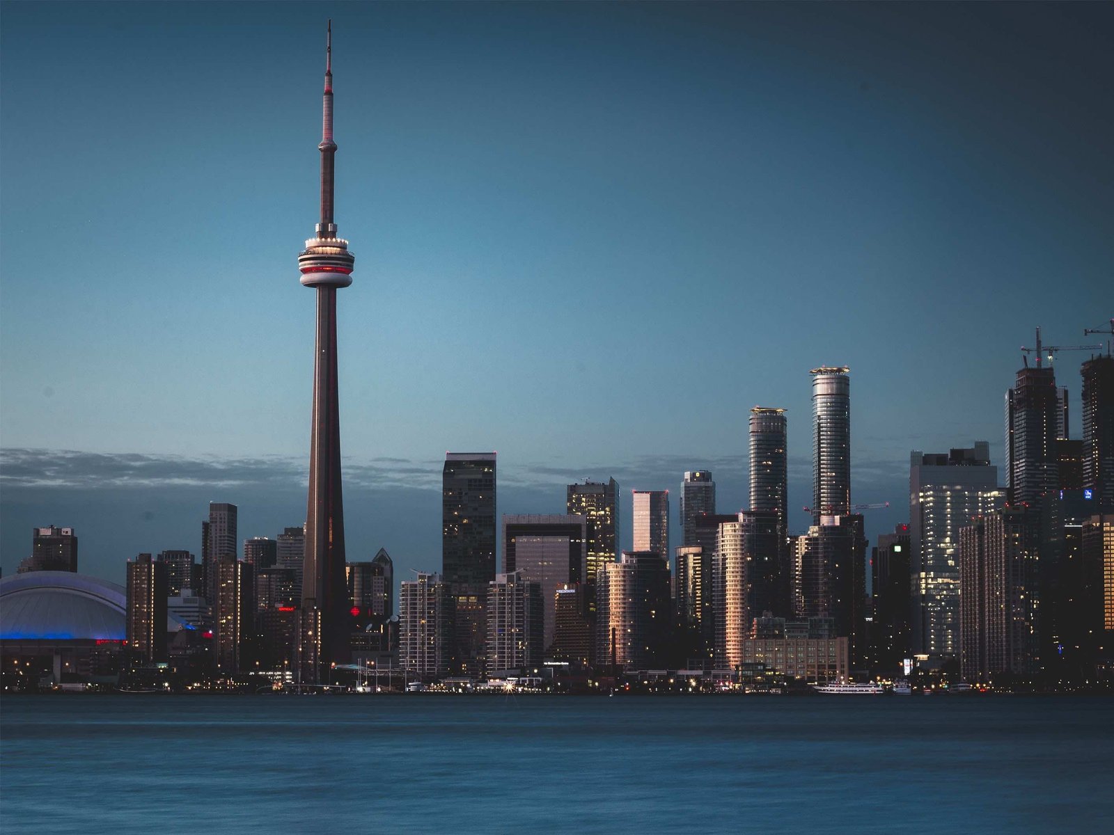 silhouette photography of city near body water canada toronto 2k