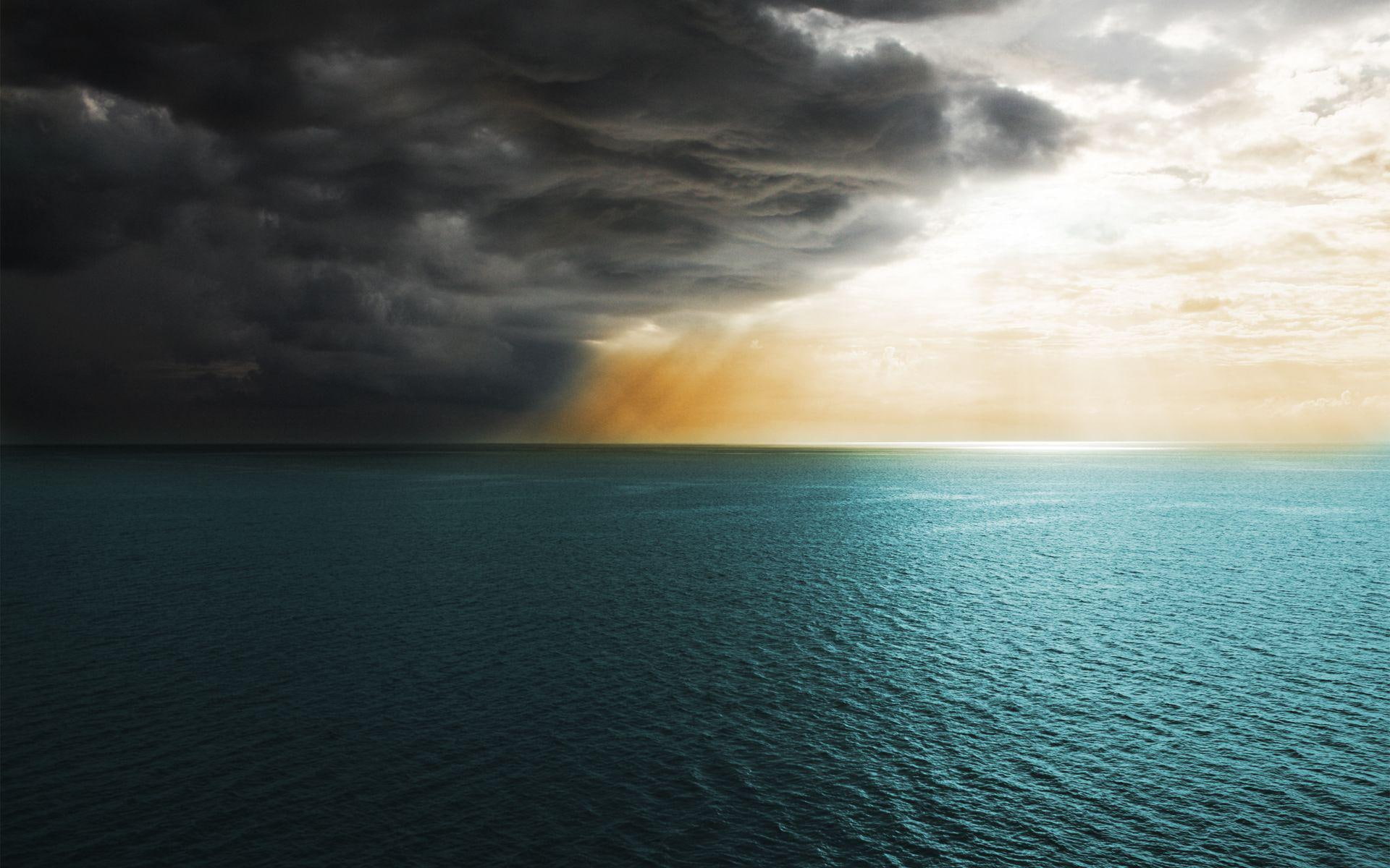 Storm clouds covering the sun body of water and dark 2k