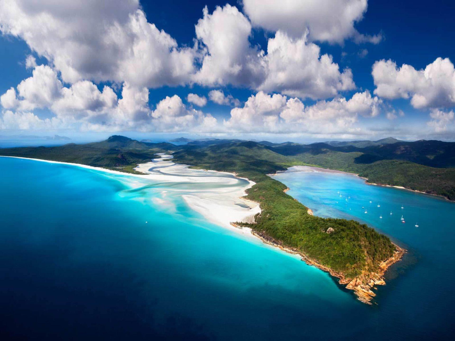 Whitsunday Isls aerial photo of island and ocean with Columbus clouds 2k