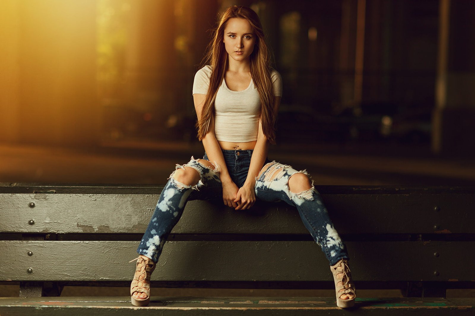 women's blue distressed jeans sitting portrait pierced navel 2k