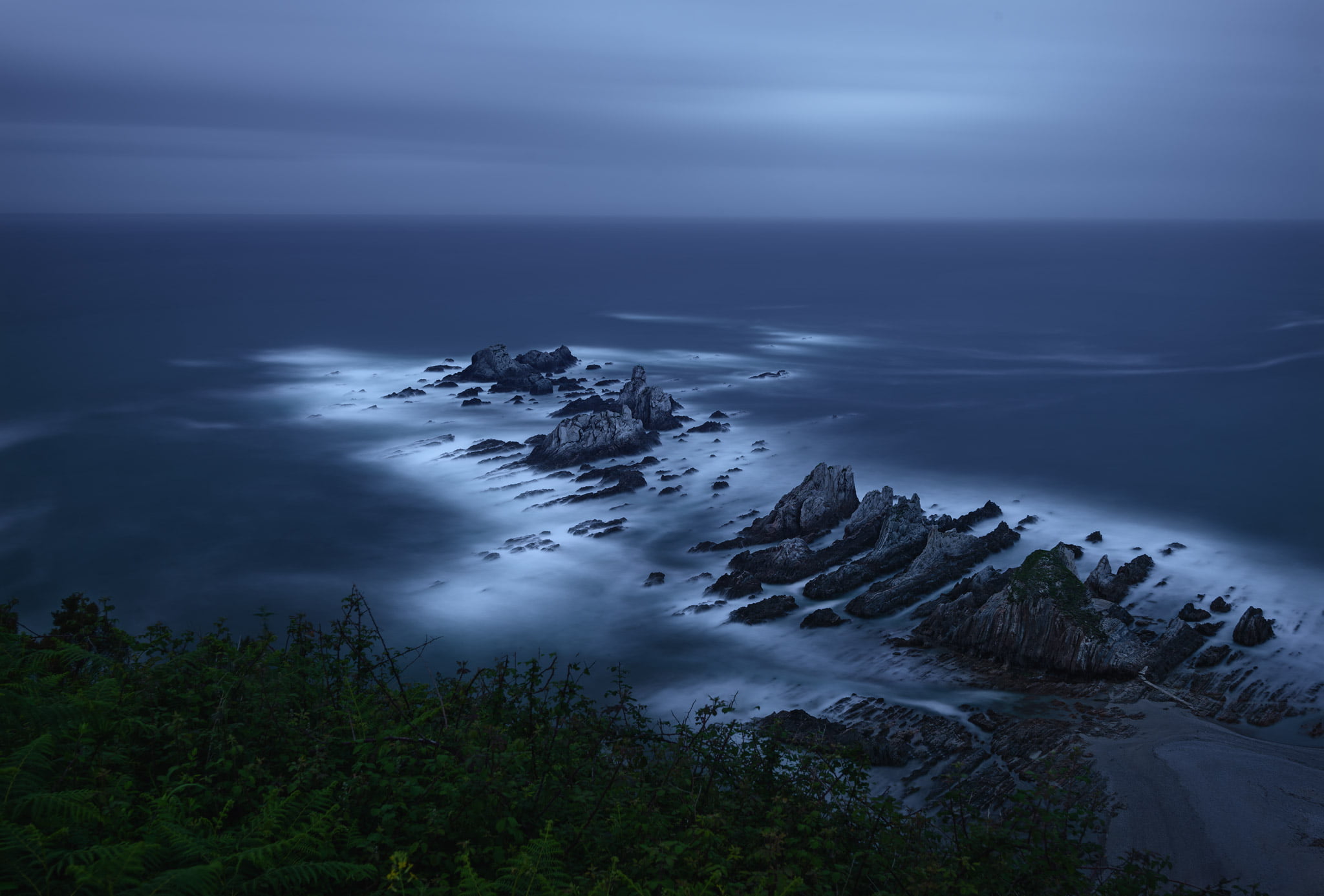 gray rocks on body of water under clouds Reconnoiter beach 2k
