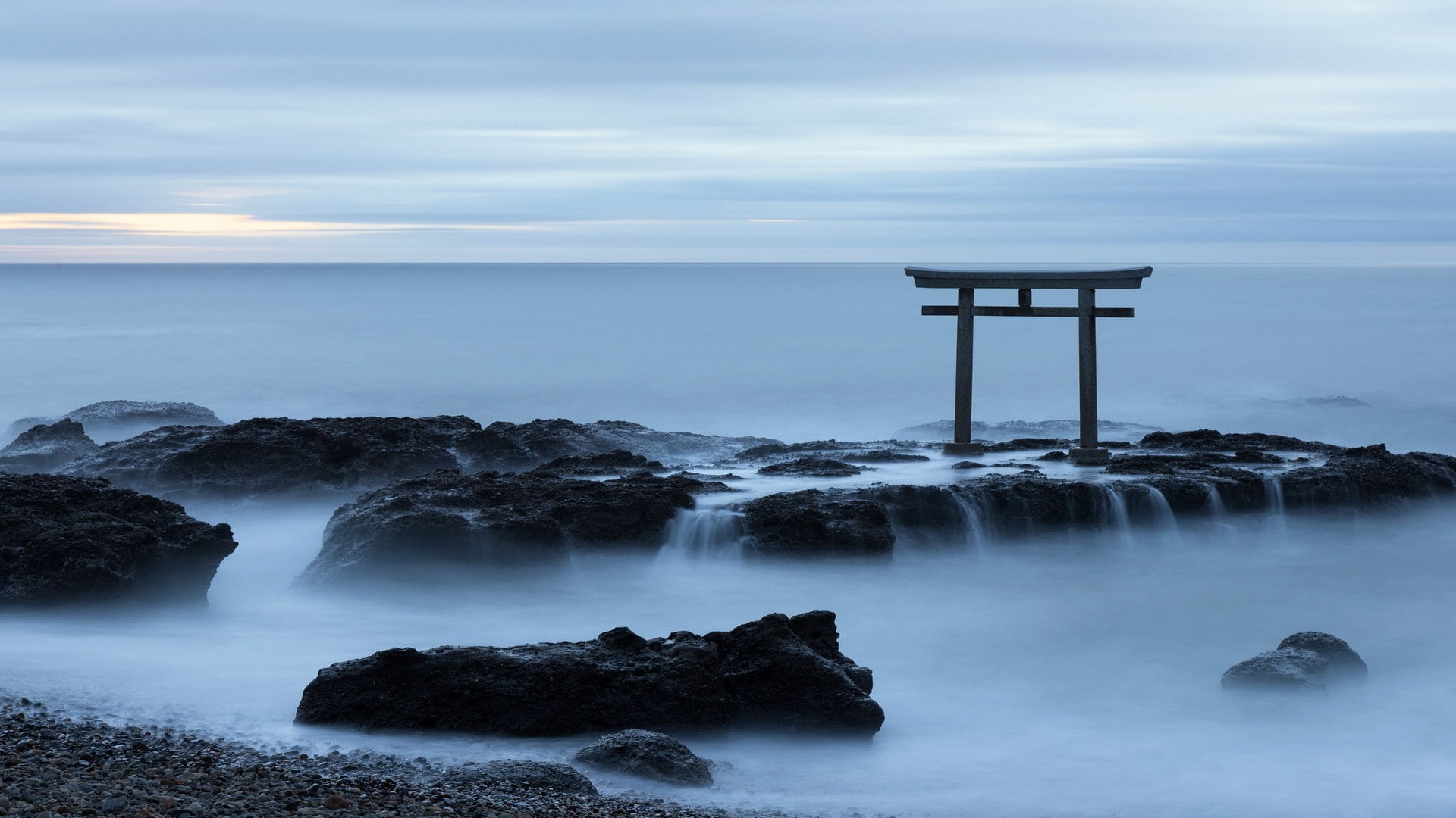 Japanese torii gates coast sea water rock sky long exposure 2k