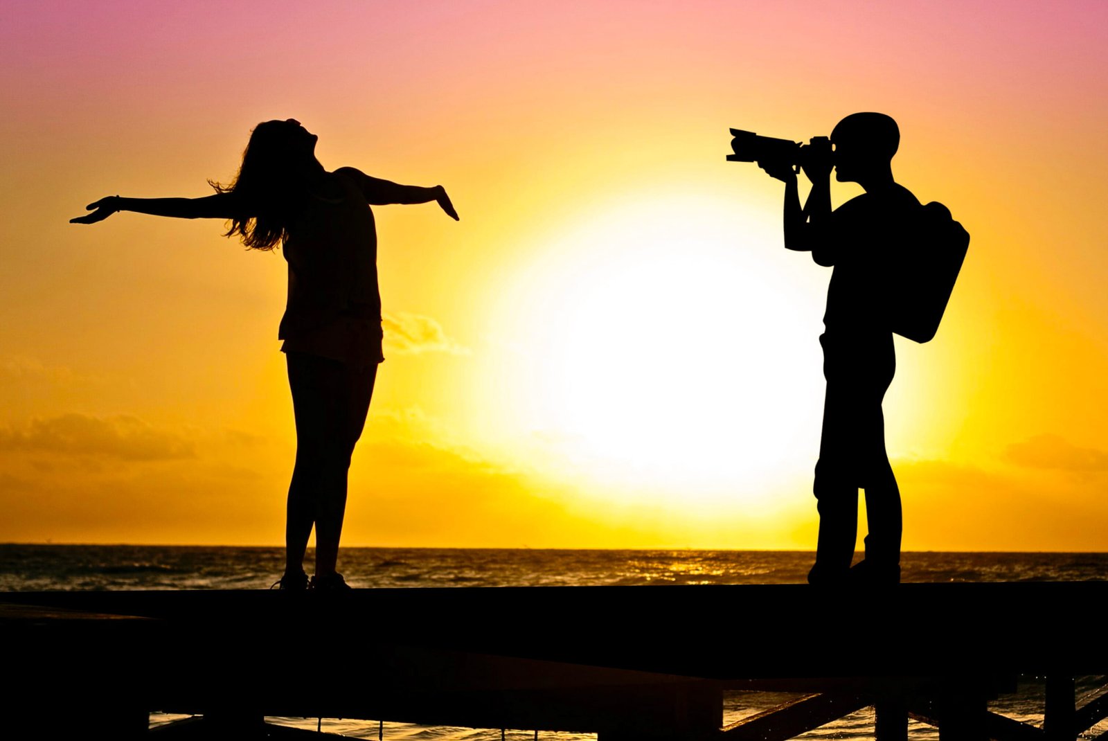 Photo illustration of photographer shooting photo model on the beach 2k