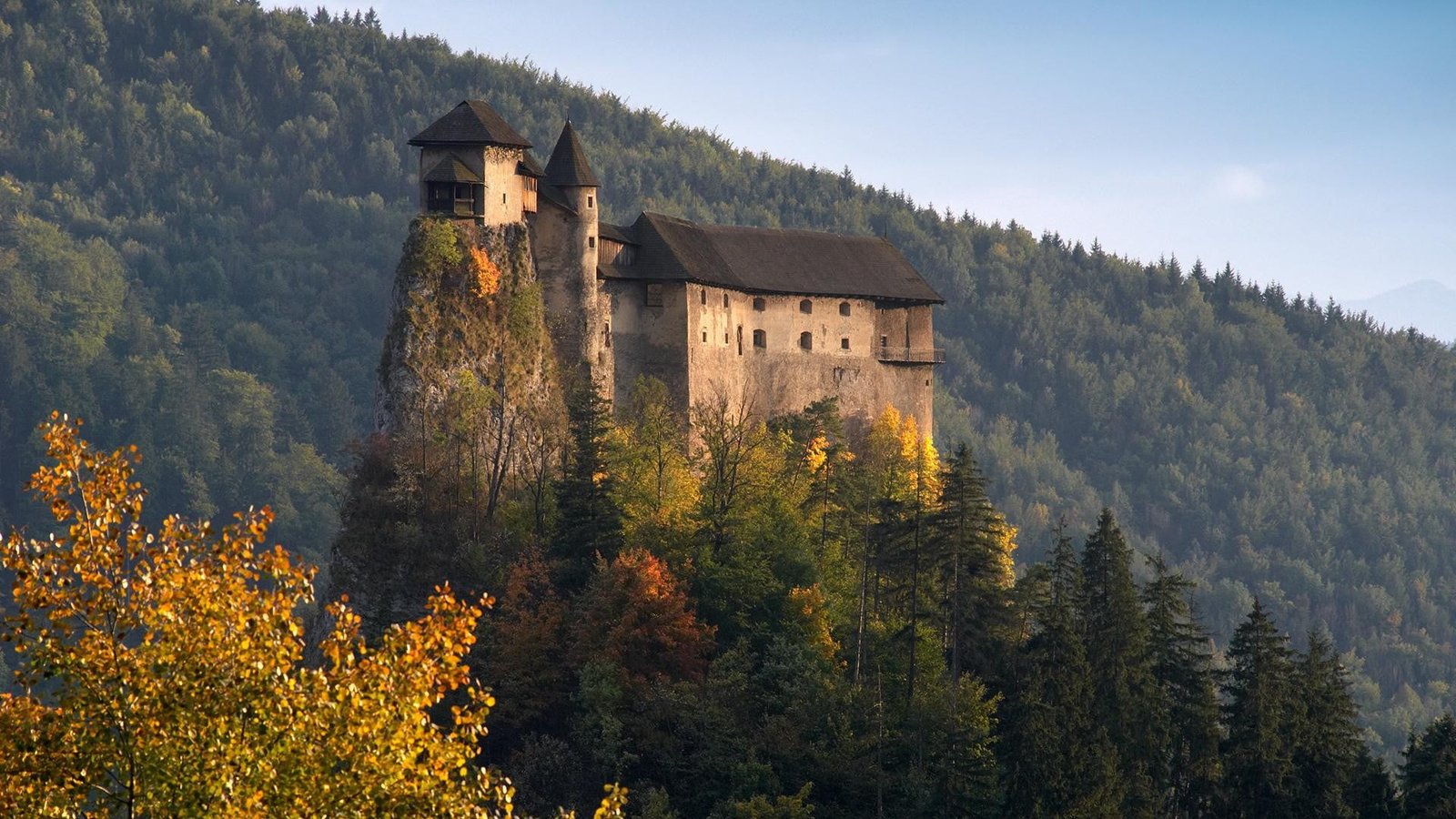 beige and black gothic castle photography of gray concrete near top mountain at daytime 2k