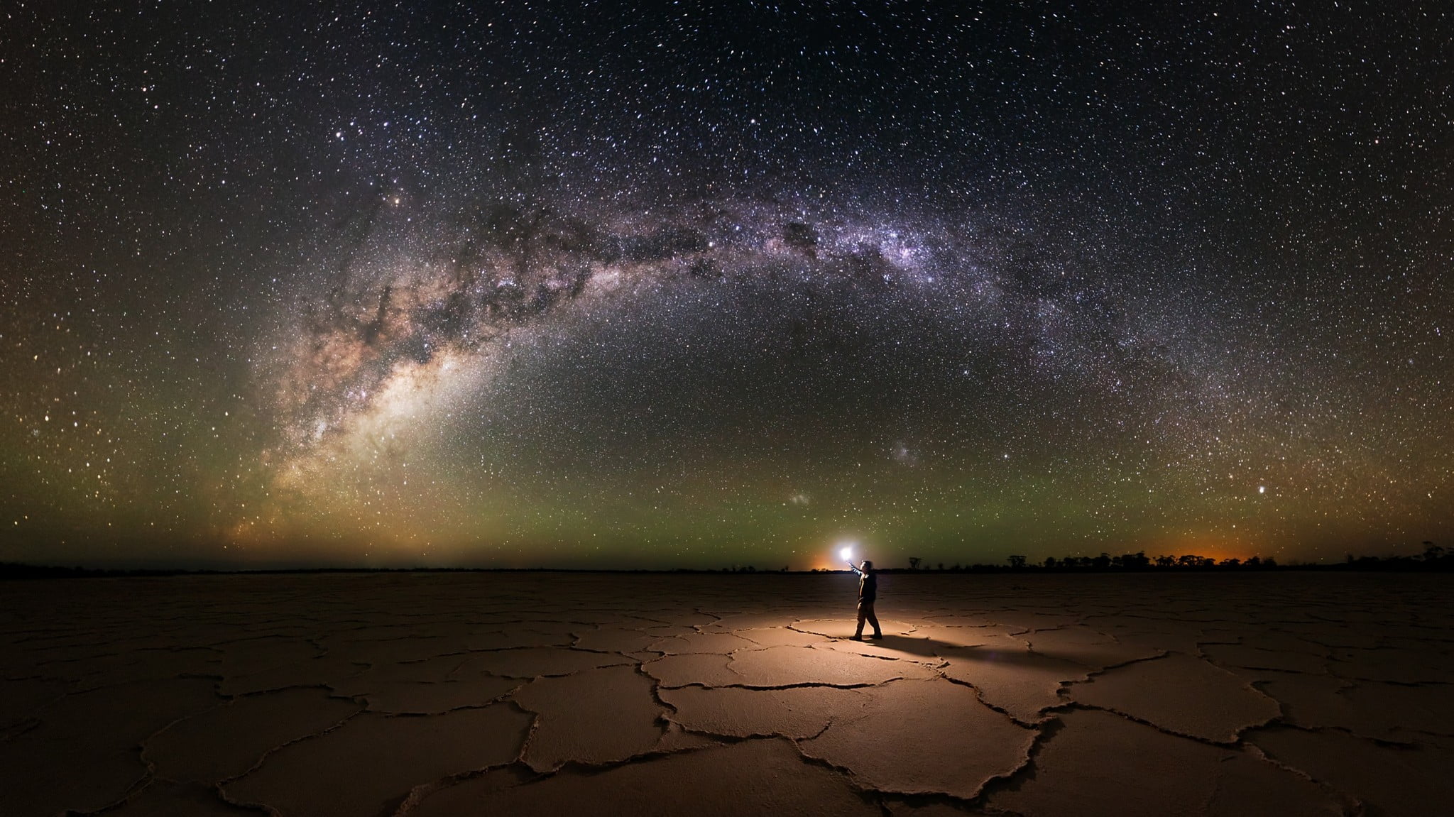 man standing near green sky nature landscape salt lakes Milky Way 2k