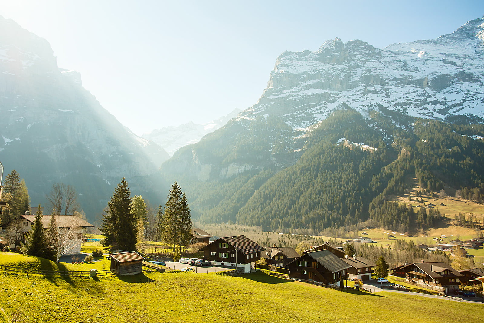 landscape photograph of town near mountains grindelwald switzerland 2k