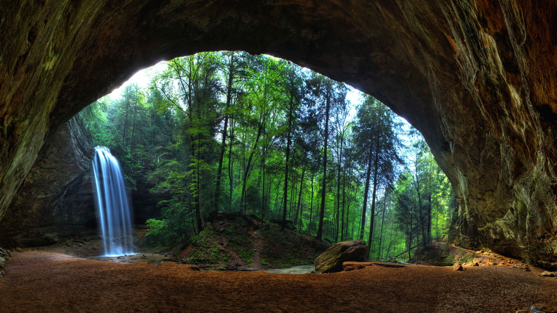 waterfalls near trees and cave during day nature landscape 2k