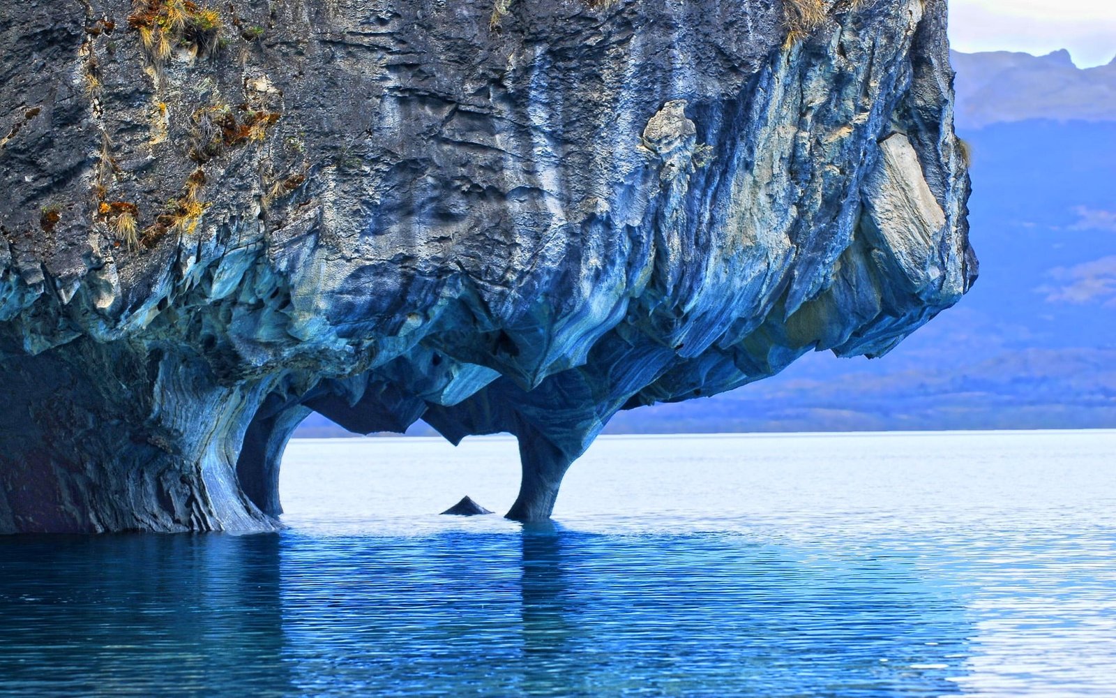 rock formation over body of water nature landscape lake marble 2k