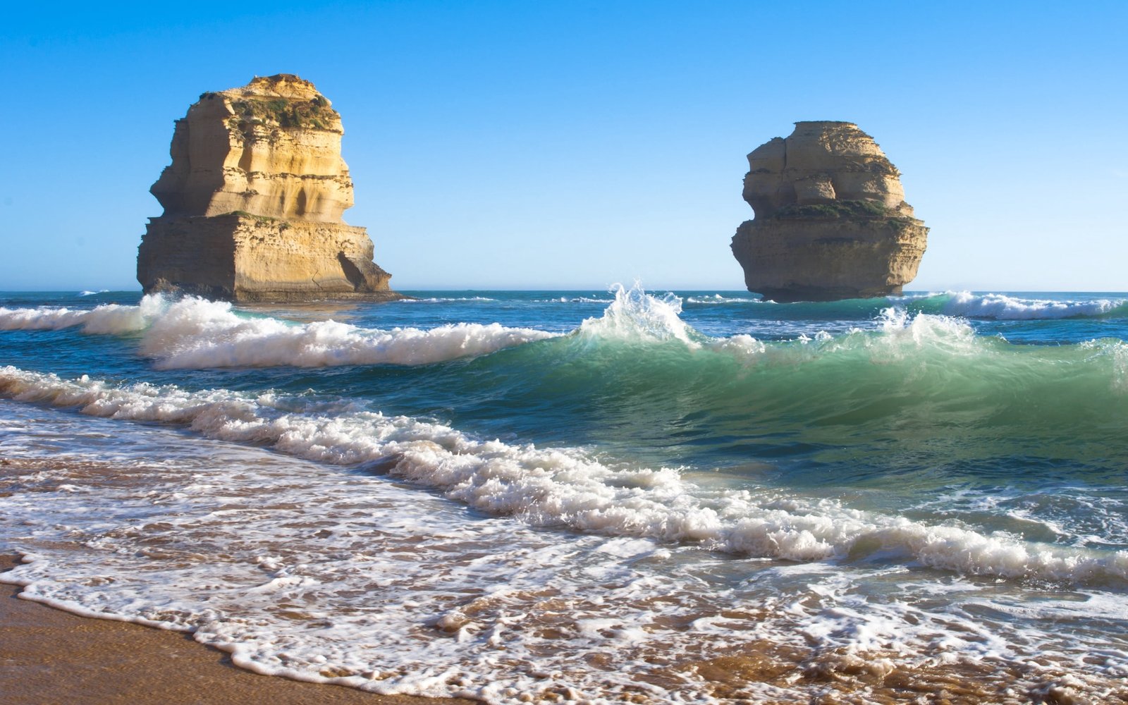two brown rock formations sea beach waves rocks Object 2k
