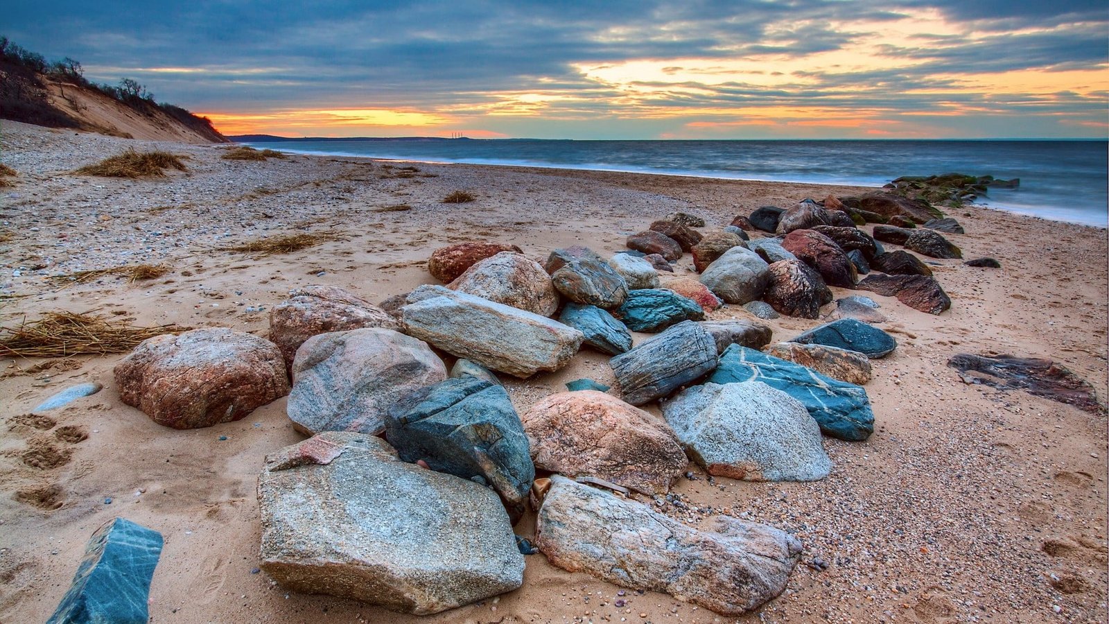 brown and blue stone lot water sky clouds beach sea land 2k