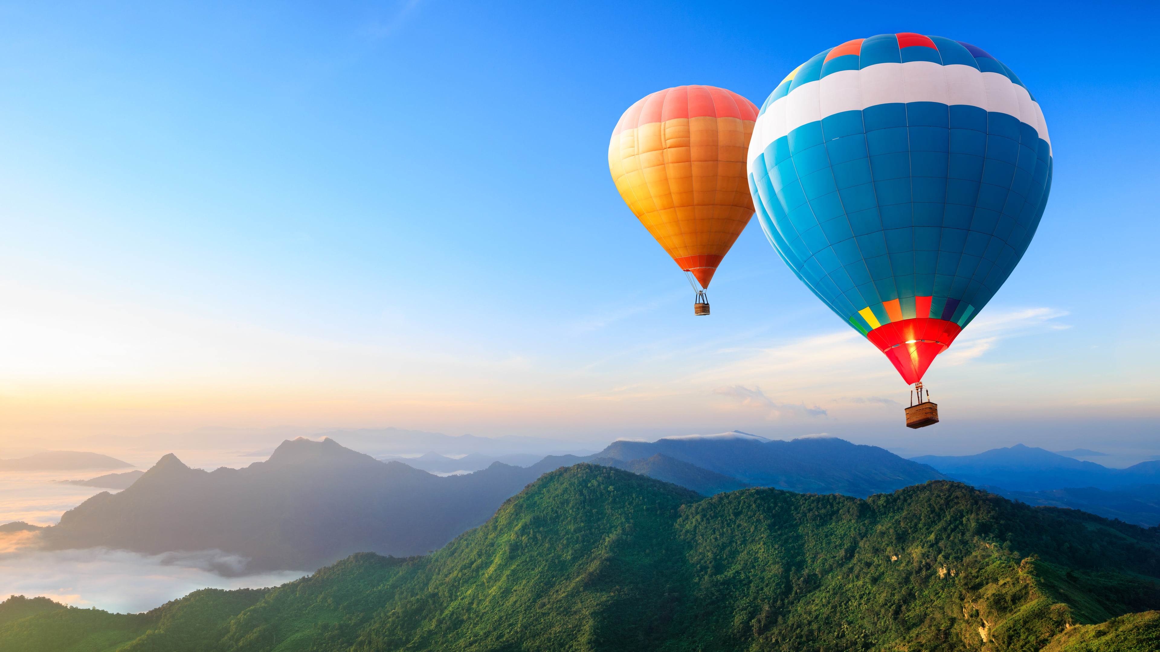 blue and white hot air balloon illustration two orange balloons airborn over mountains 2k 4k