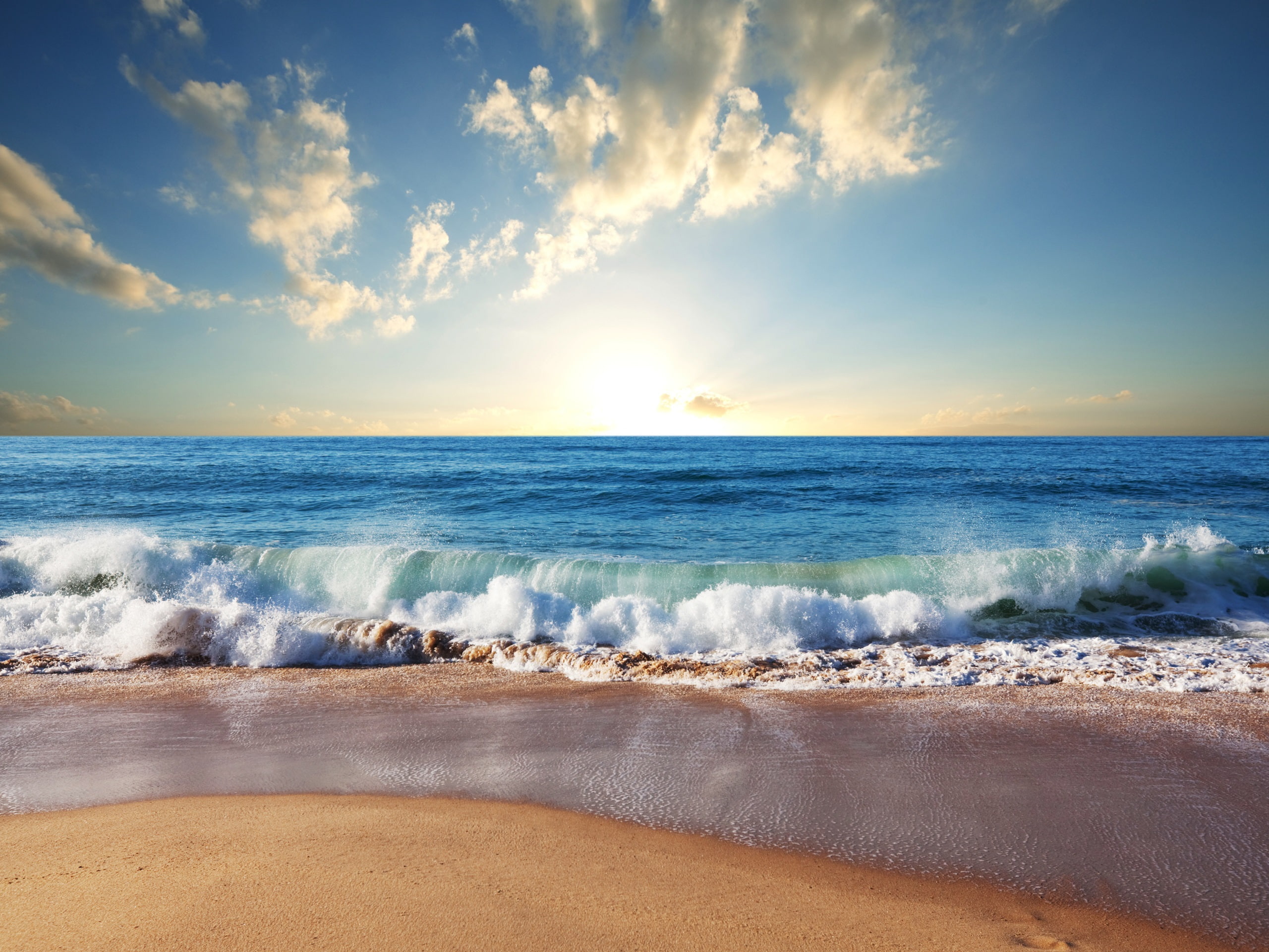 Beach sand blue sea waves clouds sun body of water under cloudy sky 2k