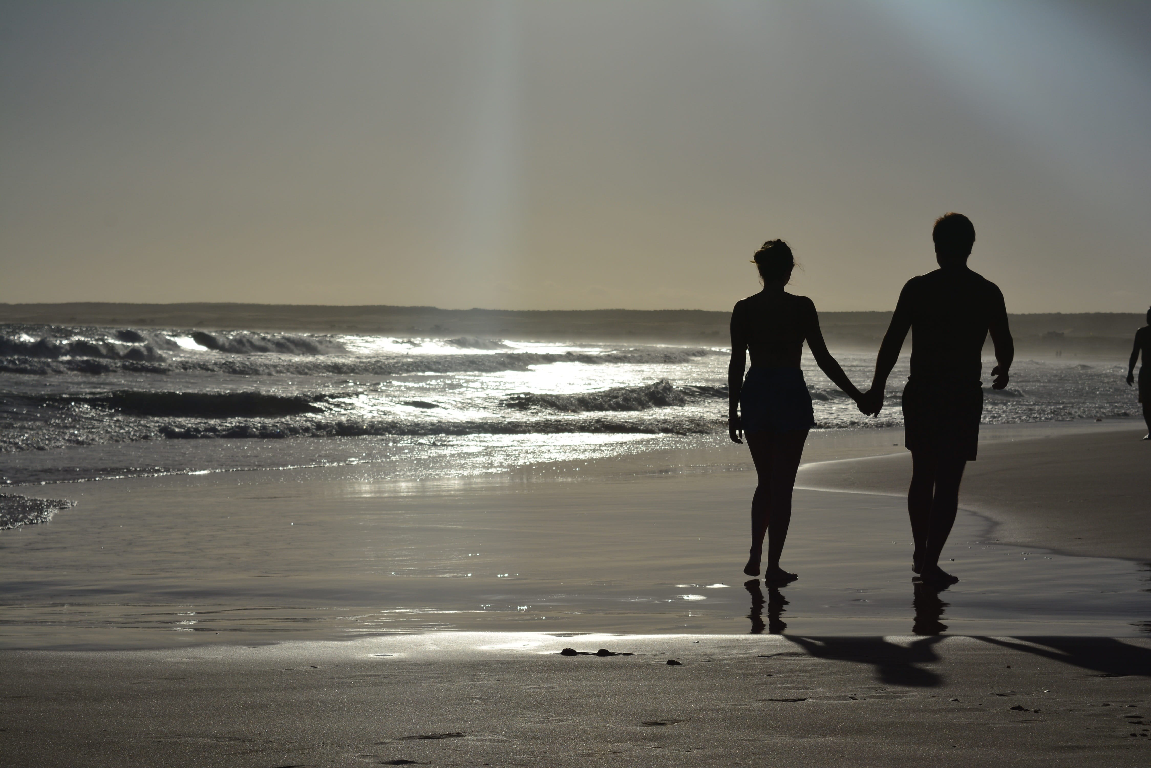 silhouette photography of man and woman near sea Beach Sunset 2k 4k