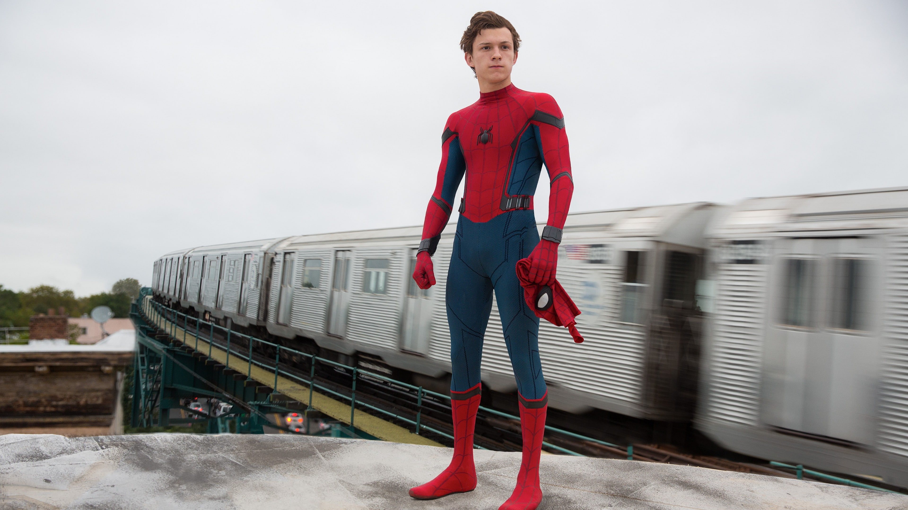 Spider Man standing near train during daytime man homecoming 2k 4k
