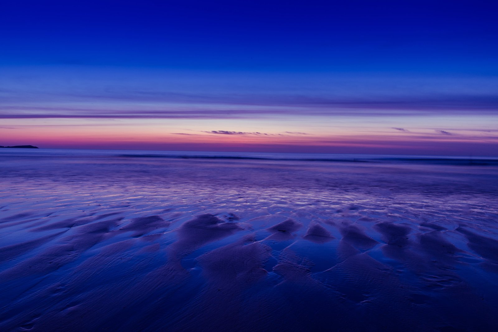 Beach at low tide during a sunset Watergate Bay in Cornwall England 2k 4k 5k