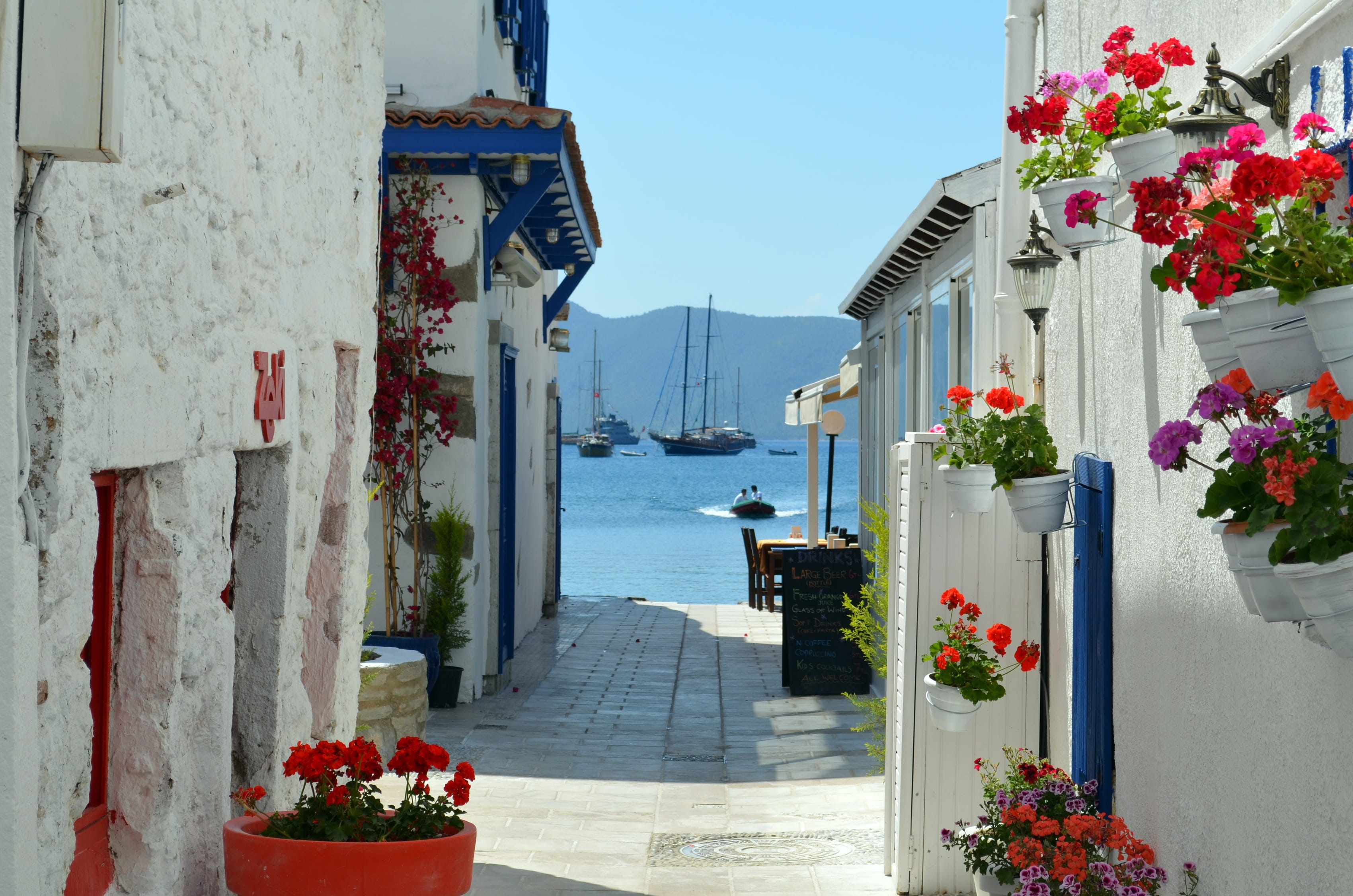 pathway between of houses with flowers during daytime Bodrum 2k