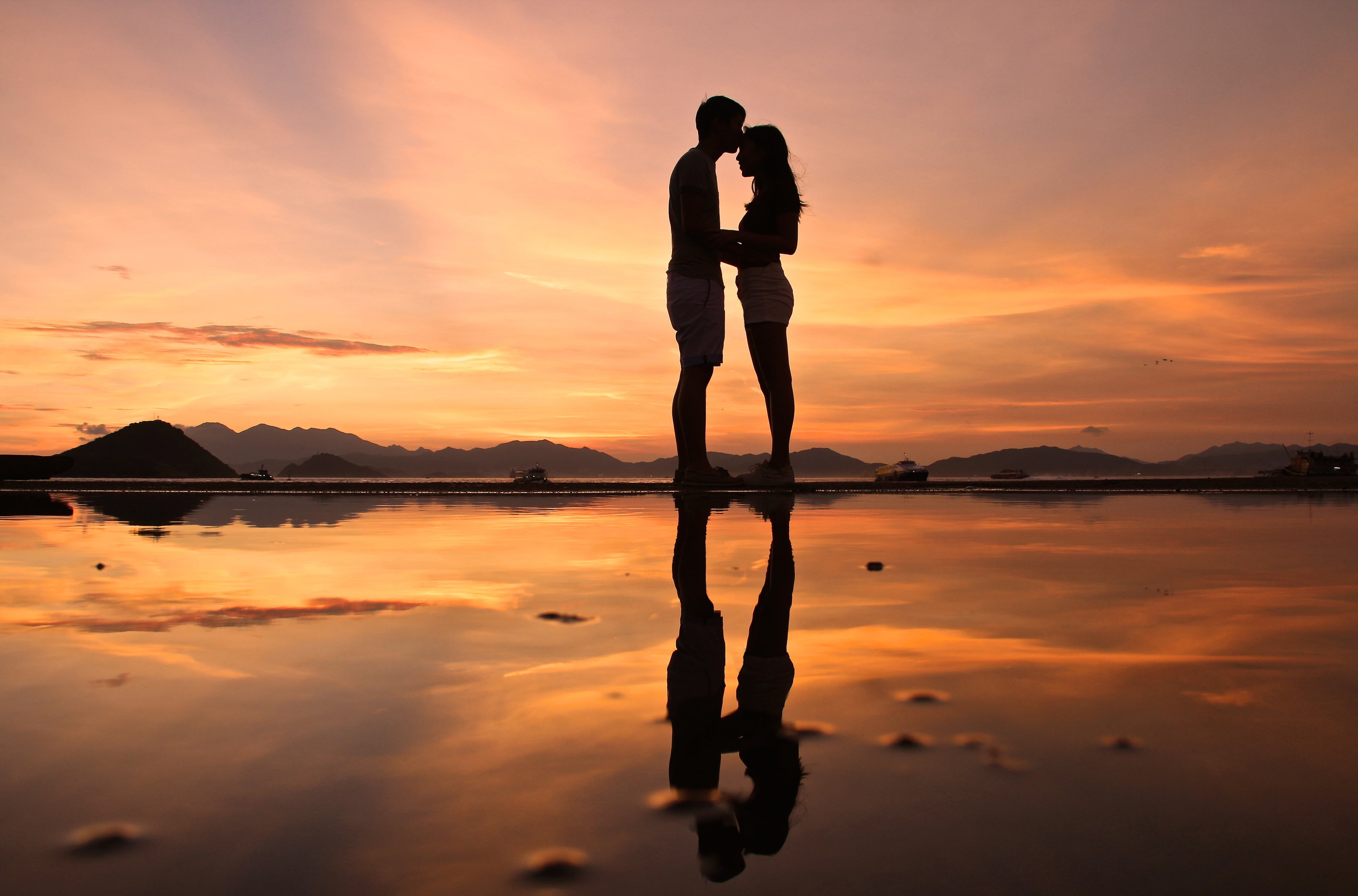 photo of man and woman standing each other james sunset burning love 2k 4k 5k