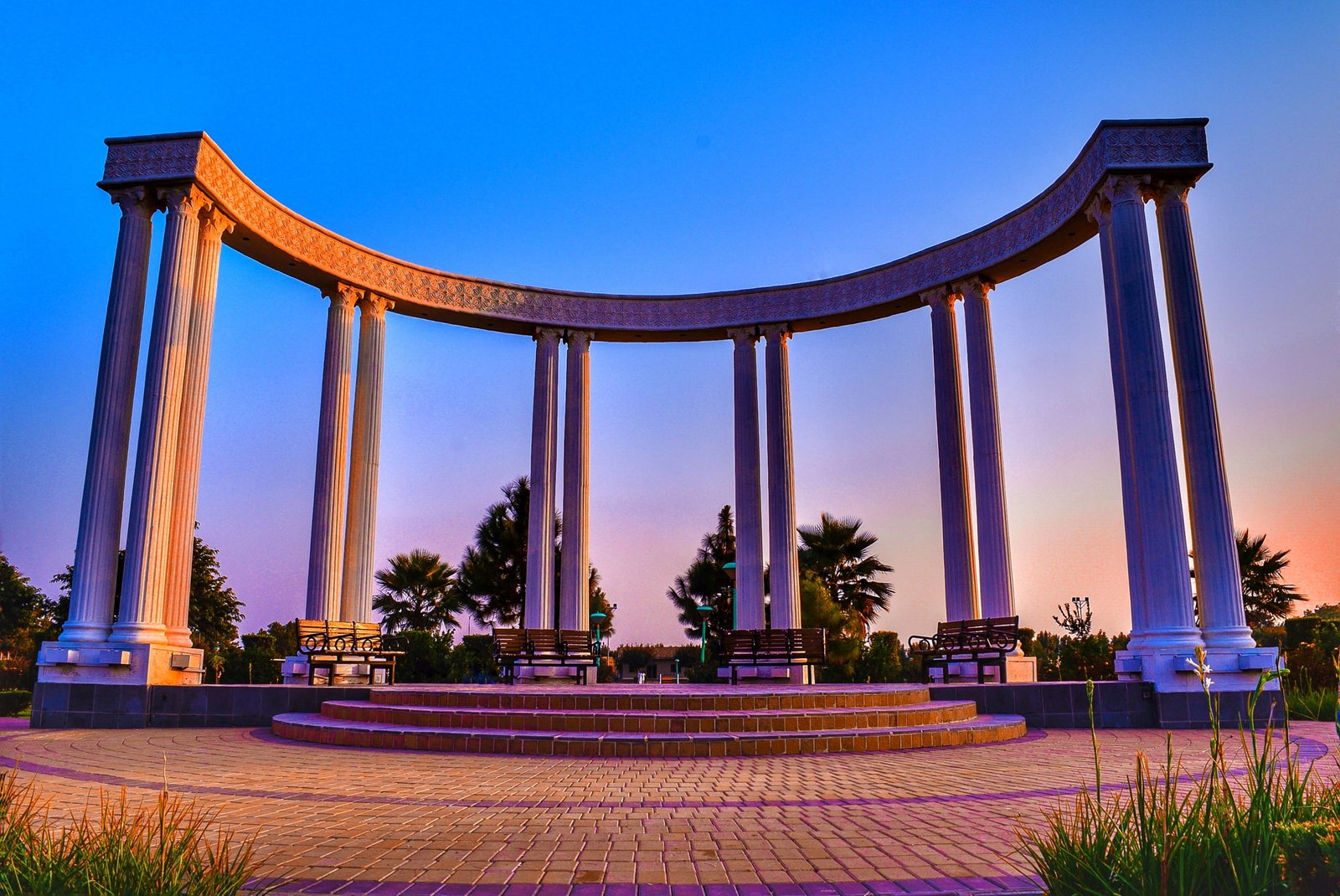 white concrete pillar under blue sky rose garden and football club 2k