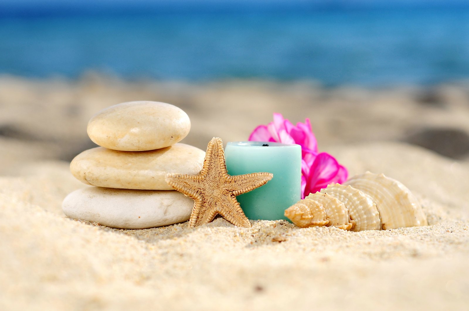 blue votive candle and three beige stones sand beach shell 2k 4k 5k