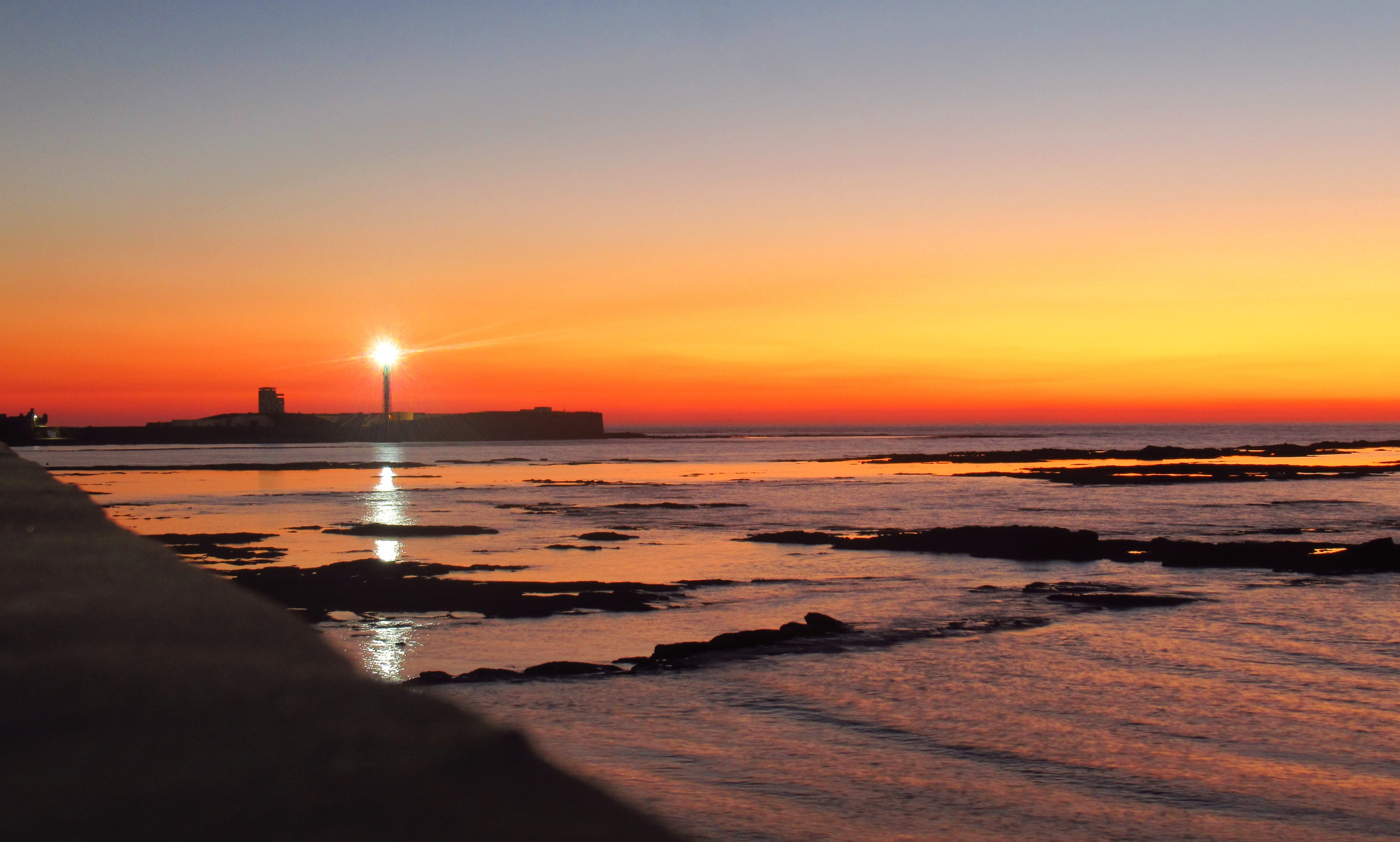 cadiz sunset beach lighthouse andalusia water tide sky 2k 4k 5k