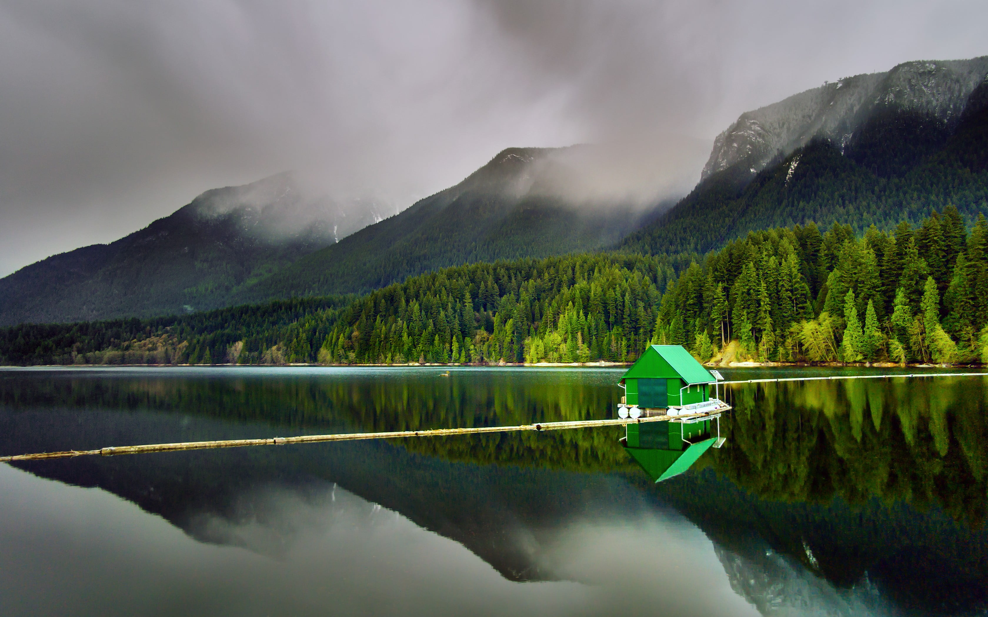 green wooden boat under gray skies during daytime nature landscape 2k
