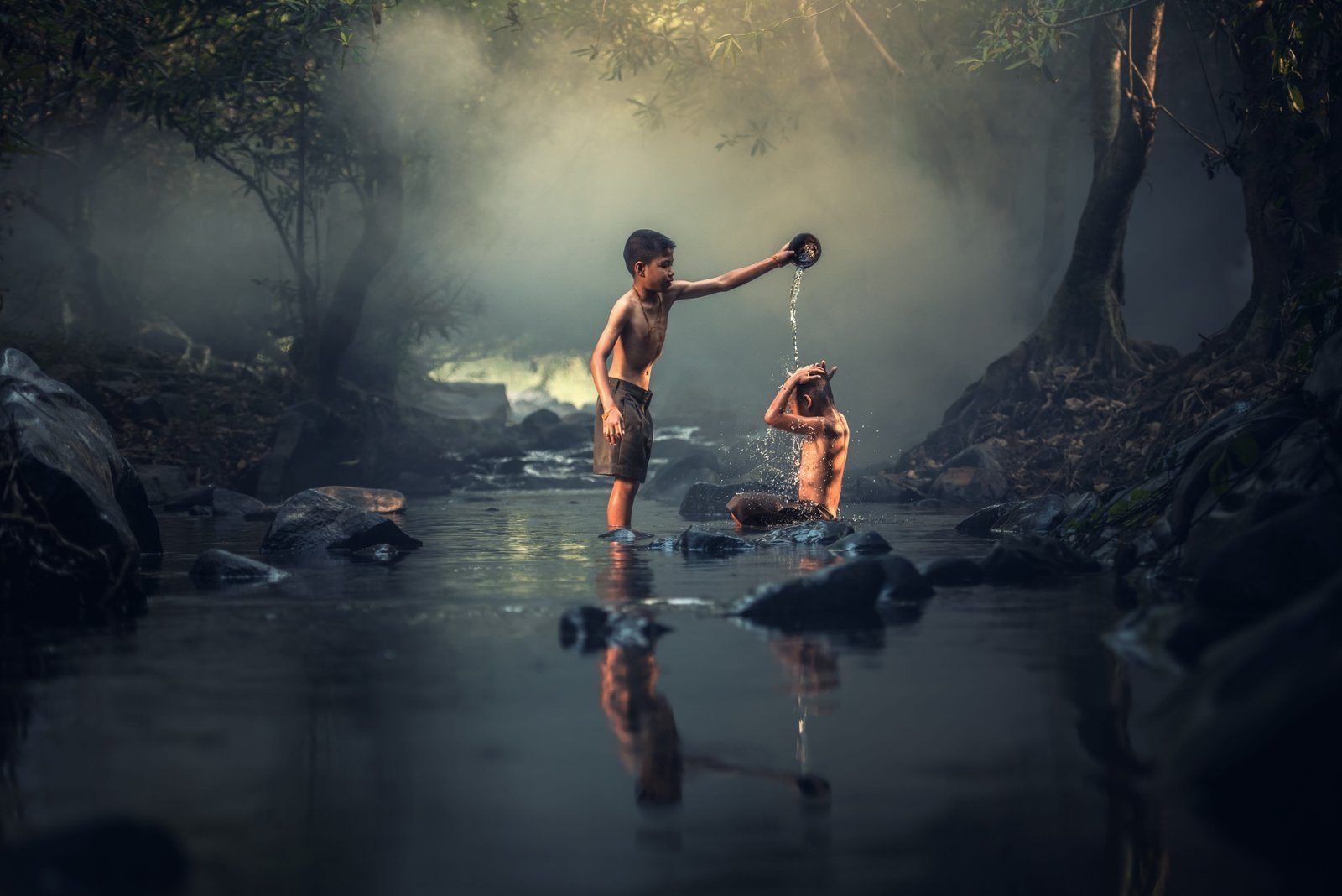 boy pouring water on person while the river asia boys creek 2k 4k 5k