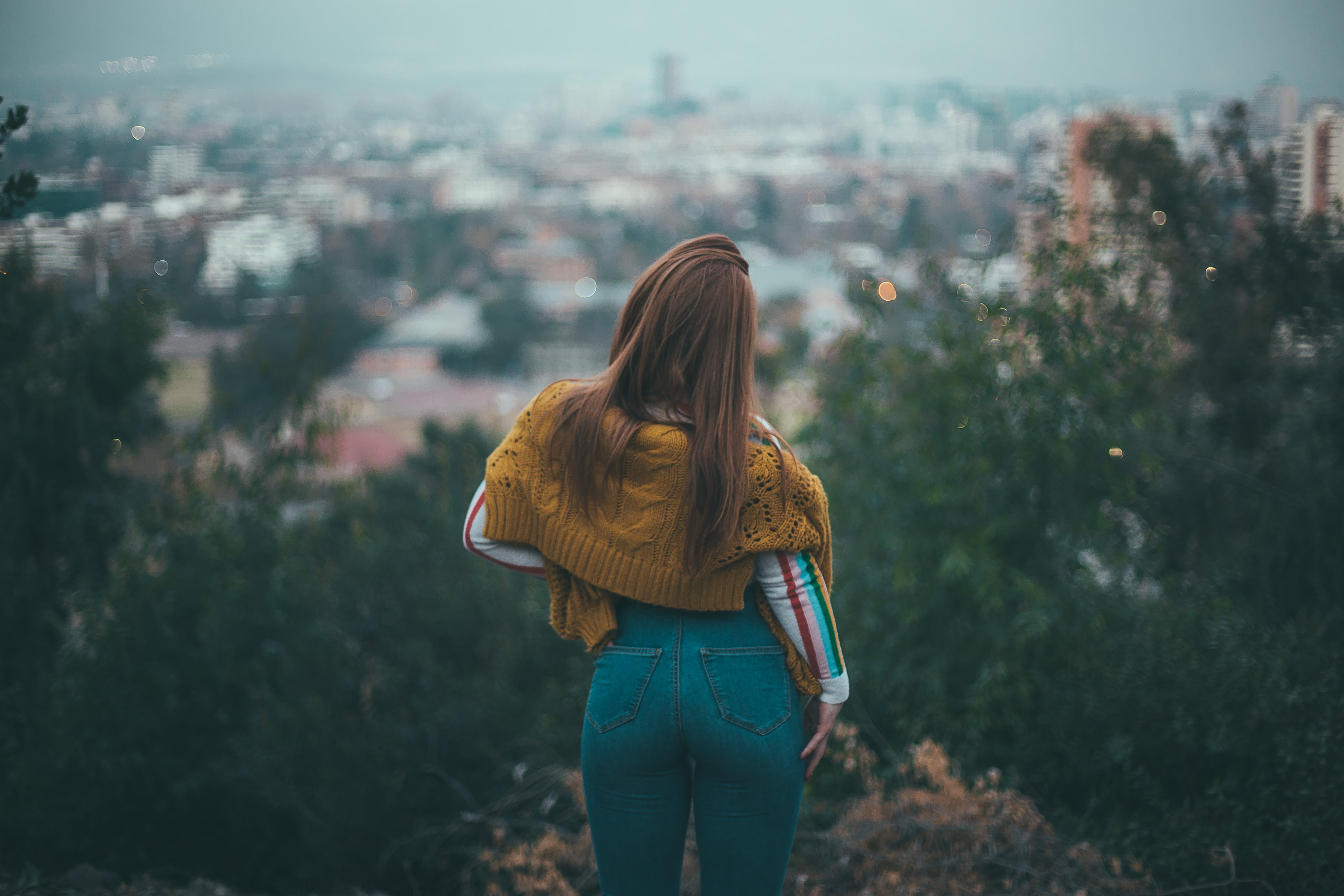 women s blue denim jeans and brown sweater portrait back cityscape 2k 4k 5k
