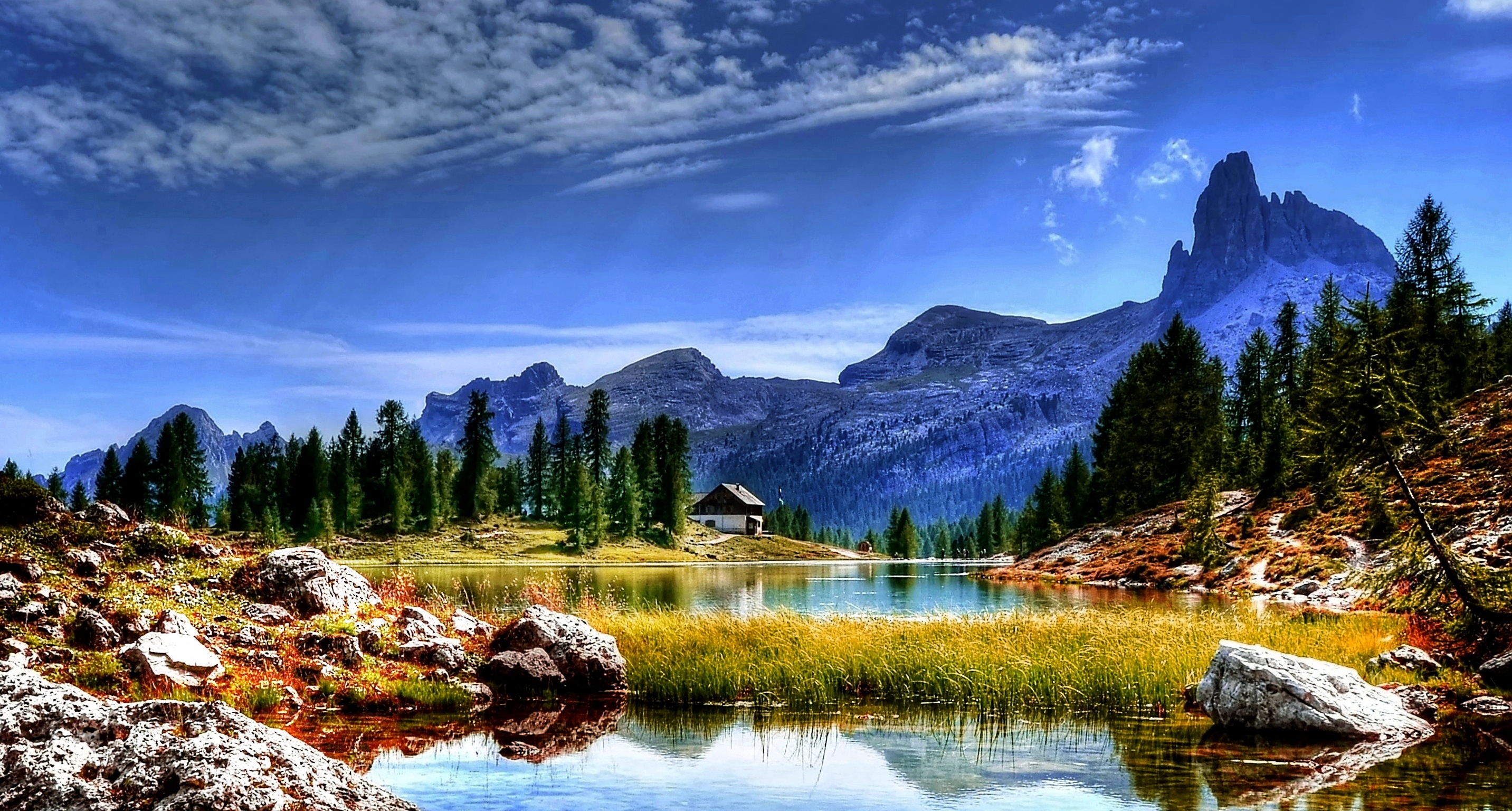 lake with background of mountain dolomites mountains landscape 2k