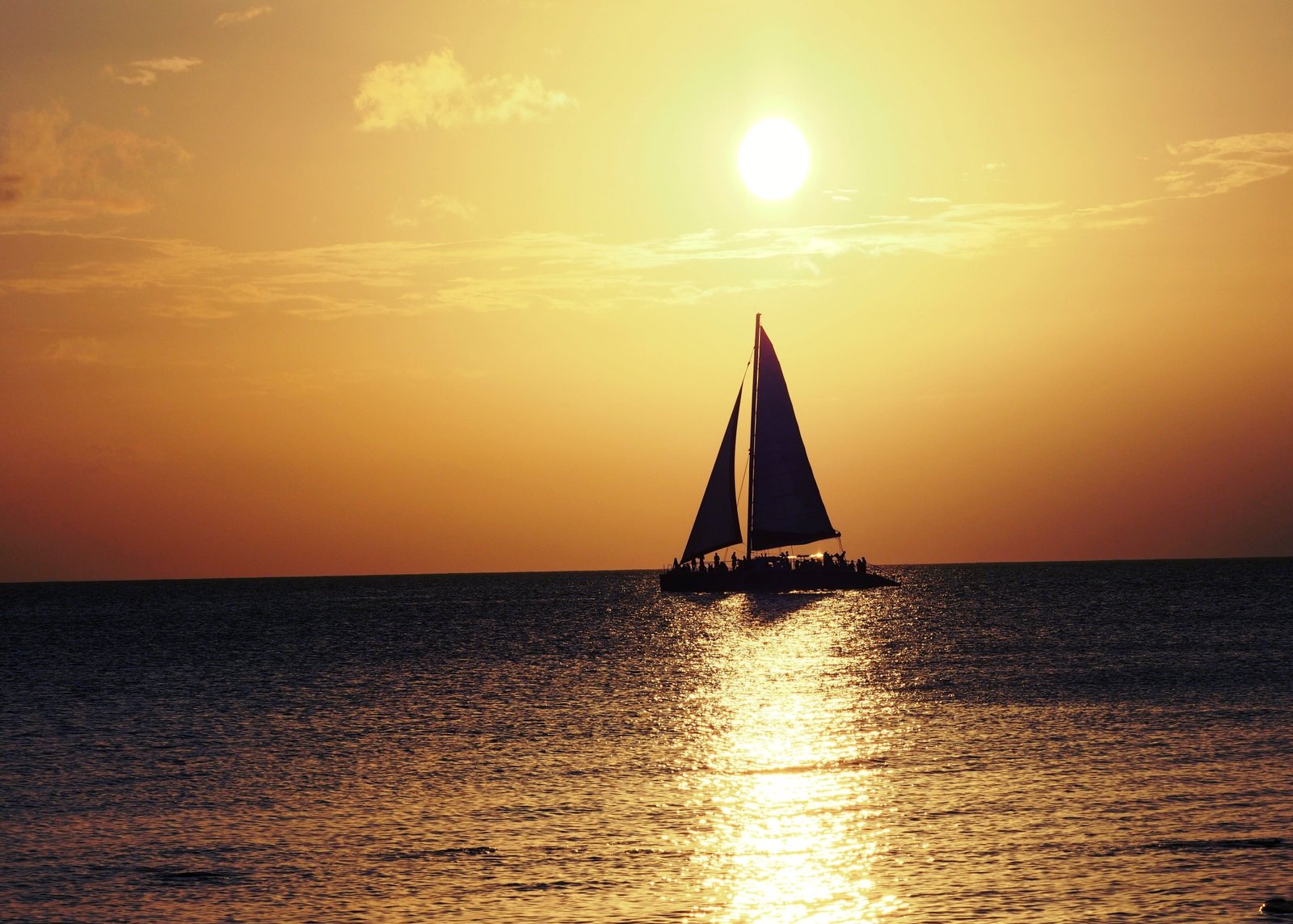 Sail Boat on sea during sunset cayman islands 2k 4k