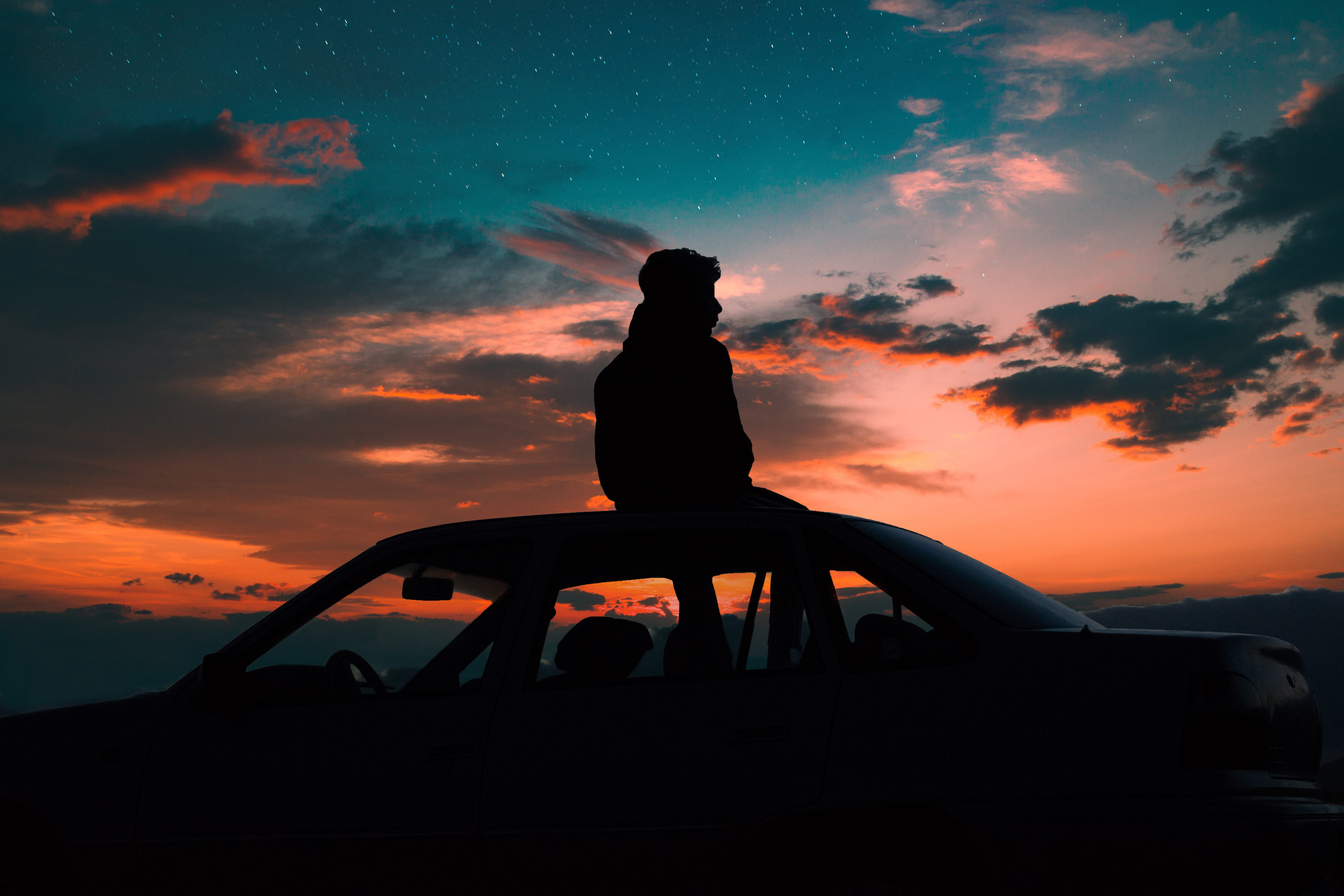 silhouette of man sitting on car roof person cloud sunset 2k 4k 5k